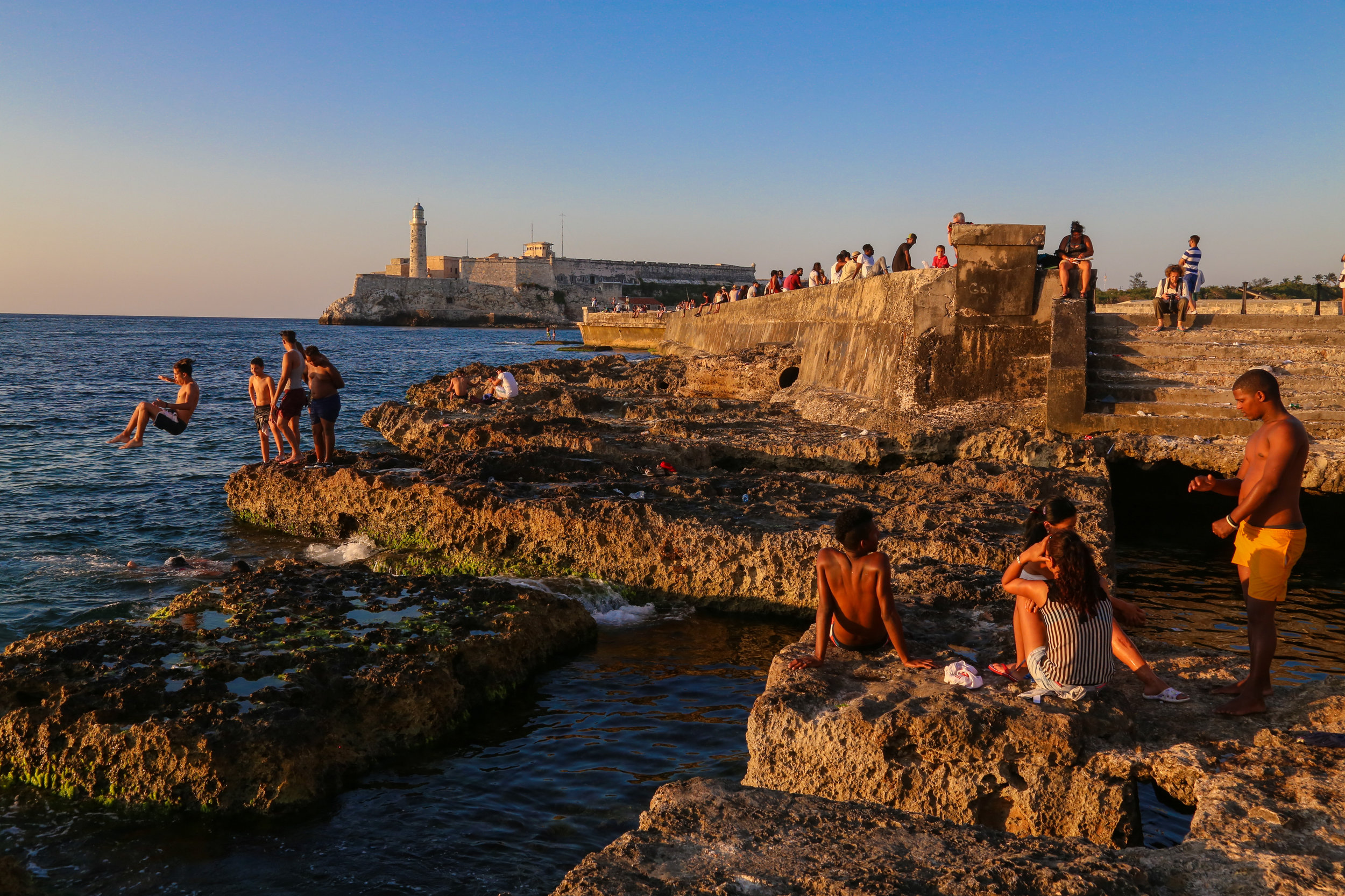 Teenagers and children alike enjoy the sunrise and catch up on a Friday afternoon at ‘El Malecon’ on April 22nd, 2016.