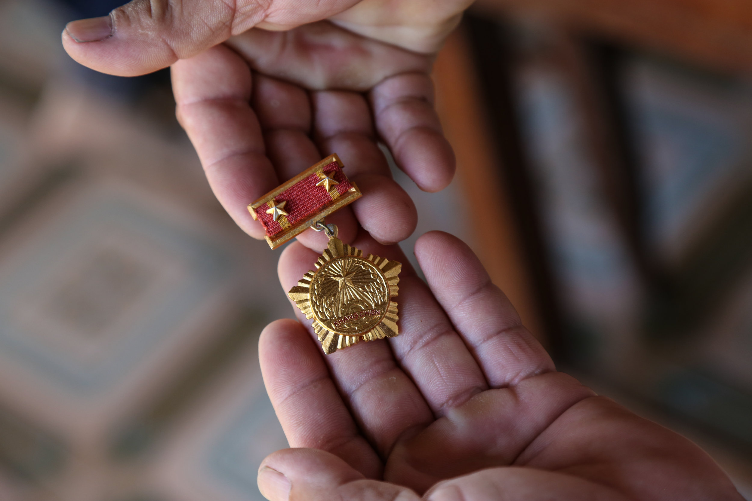 A former soldier from the Vietnamese army proudly shows his medal given by the government thanking him for his service during the war. July 31st, 2015.