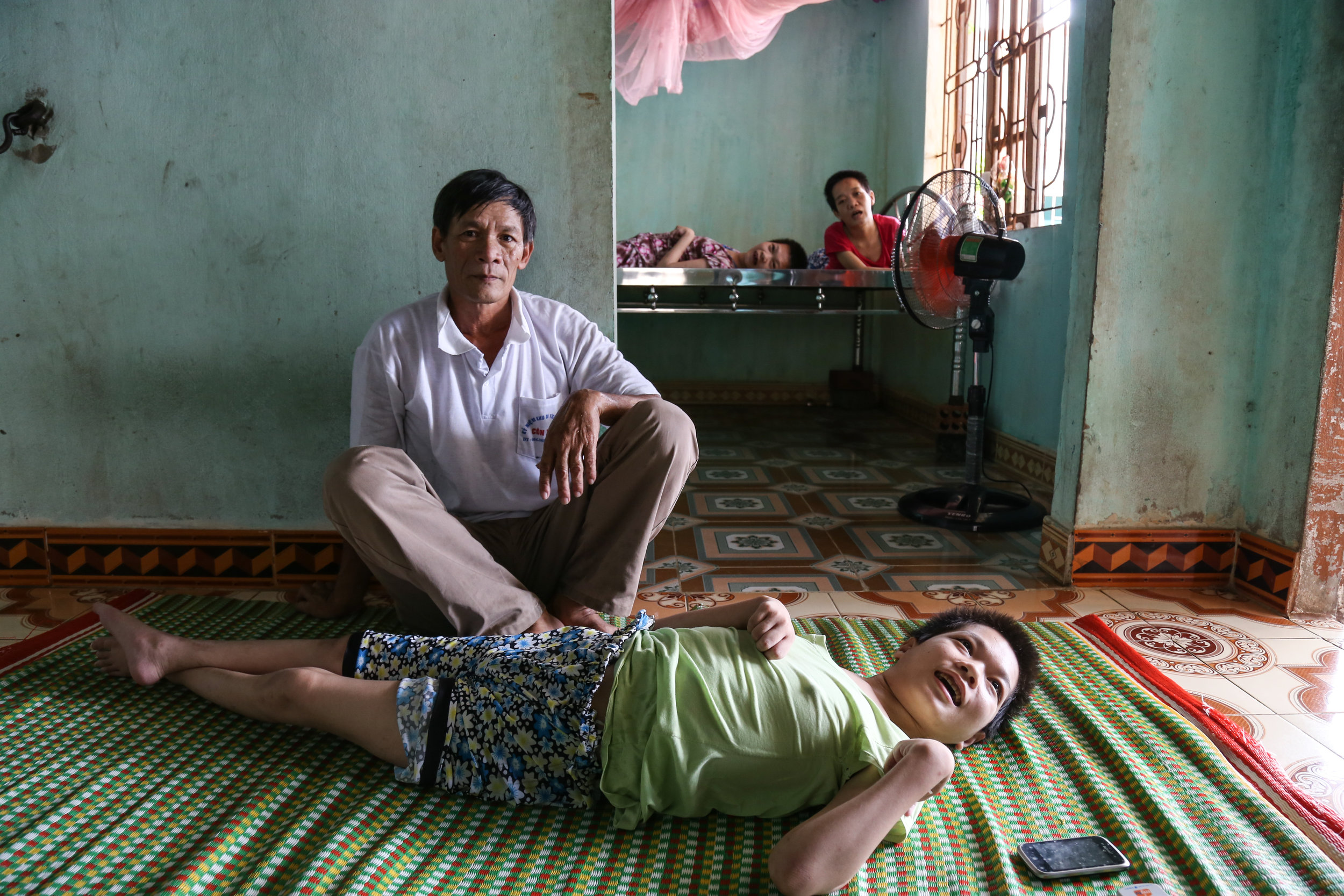 Mr. Duc and his children, all exposed to Agent Orange during an after the Vietnam war, in his home in Dong Hoi. July 16th, 2015.