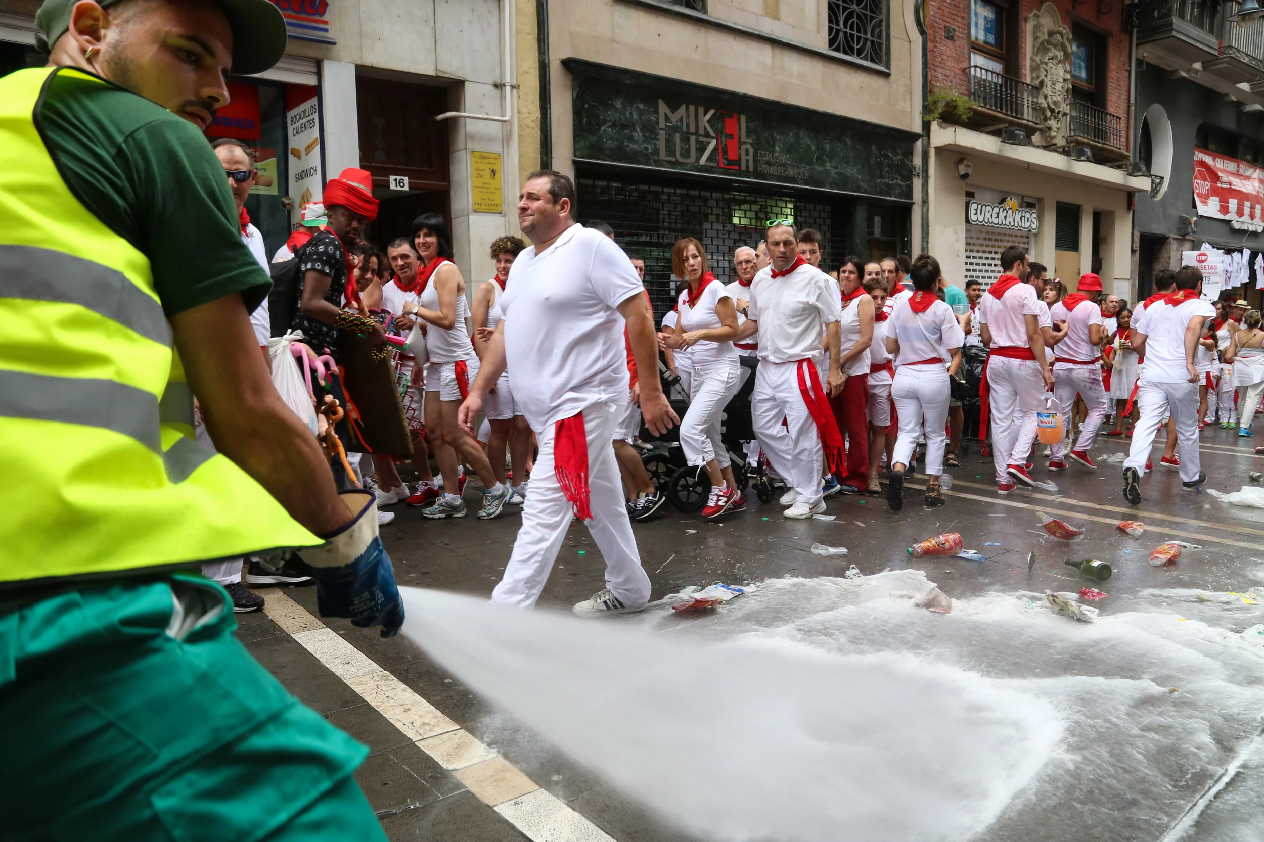 A janitor for the city of Pamplona sprays water after "El Chupinaxo" to keep the streets clean on July 6th, 2017.
