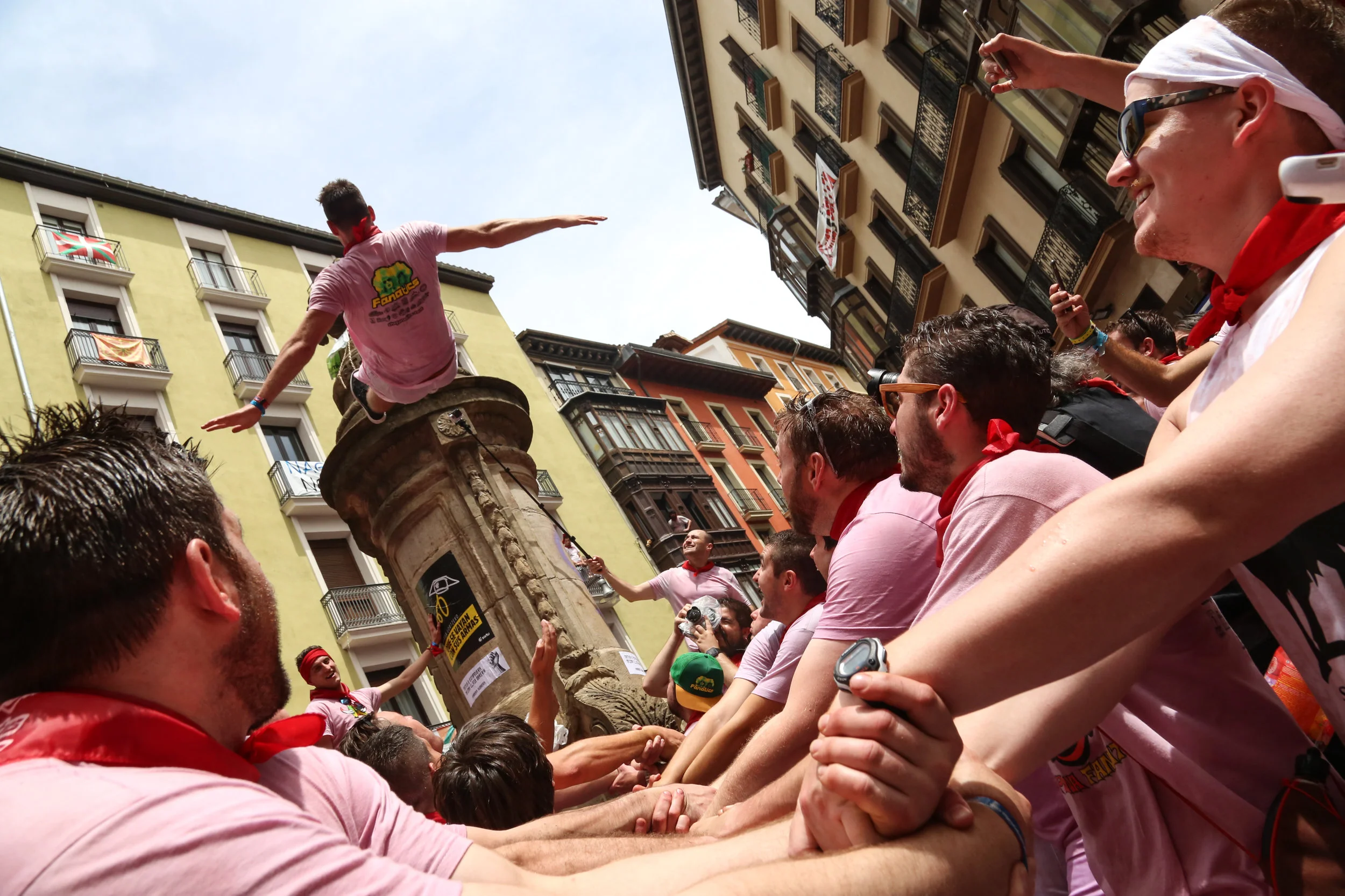 A tourist jumps from one of the fountains located in downtown Pamplona. -July 6th. 2017