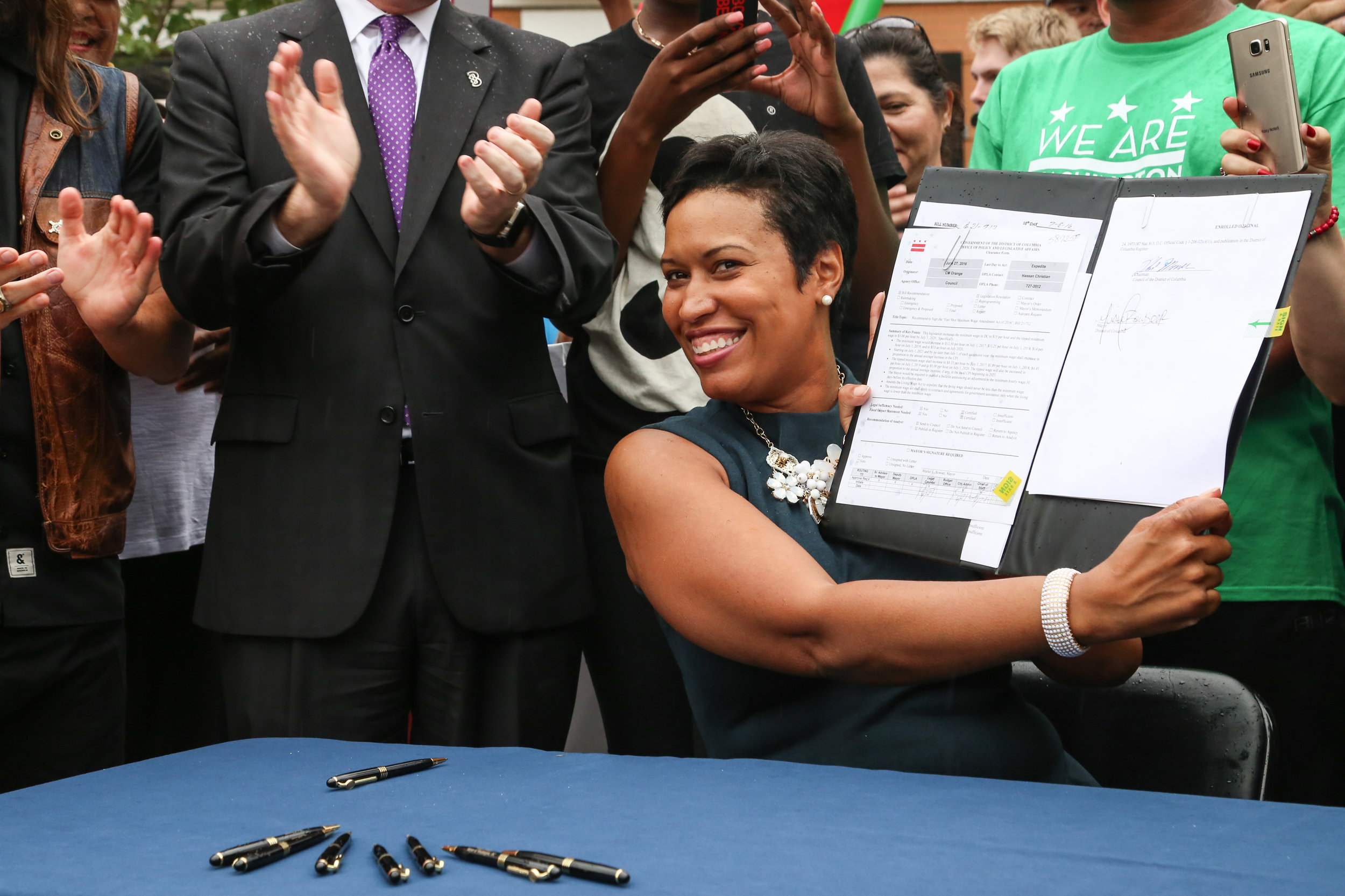 Mayor Muriel Bowser smiles after signing "The Fair Minimum Wage Amendment Act of 2016" into law at the Columbia Heights Civic Plaza, after D.C. council approved it on June 7th, 2016. The law will raise the minimum wage to $15 dollars and $5 dollars for the tipped minimum wage by 2020 in the District. 