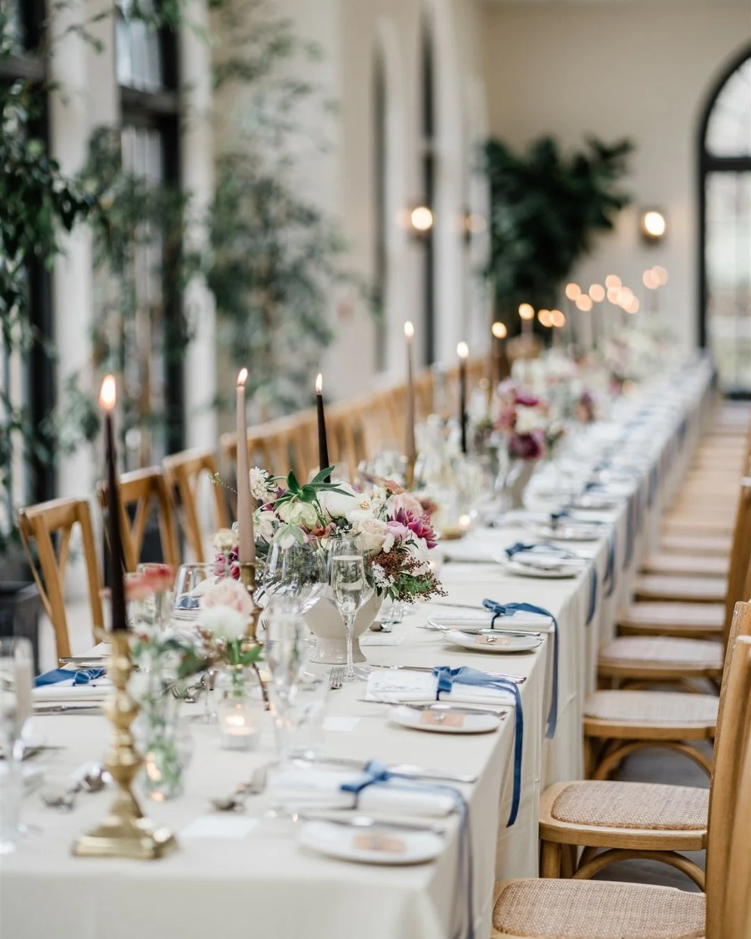 Starting to put together the look for your wedding day? Here's some beautiful inspiration from Amelia and Matthew's reception at The Fig House at Middleton Lodge. Delicate bows mixed with heady florals lit by twinkling taper candles made for a magica