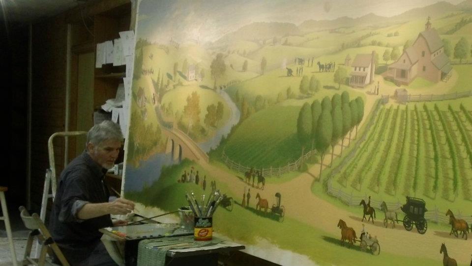 The artist working on the Bull Run Winery Mural.