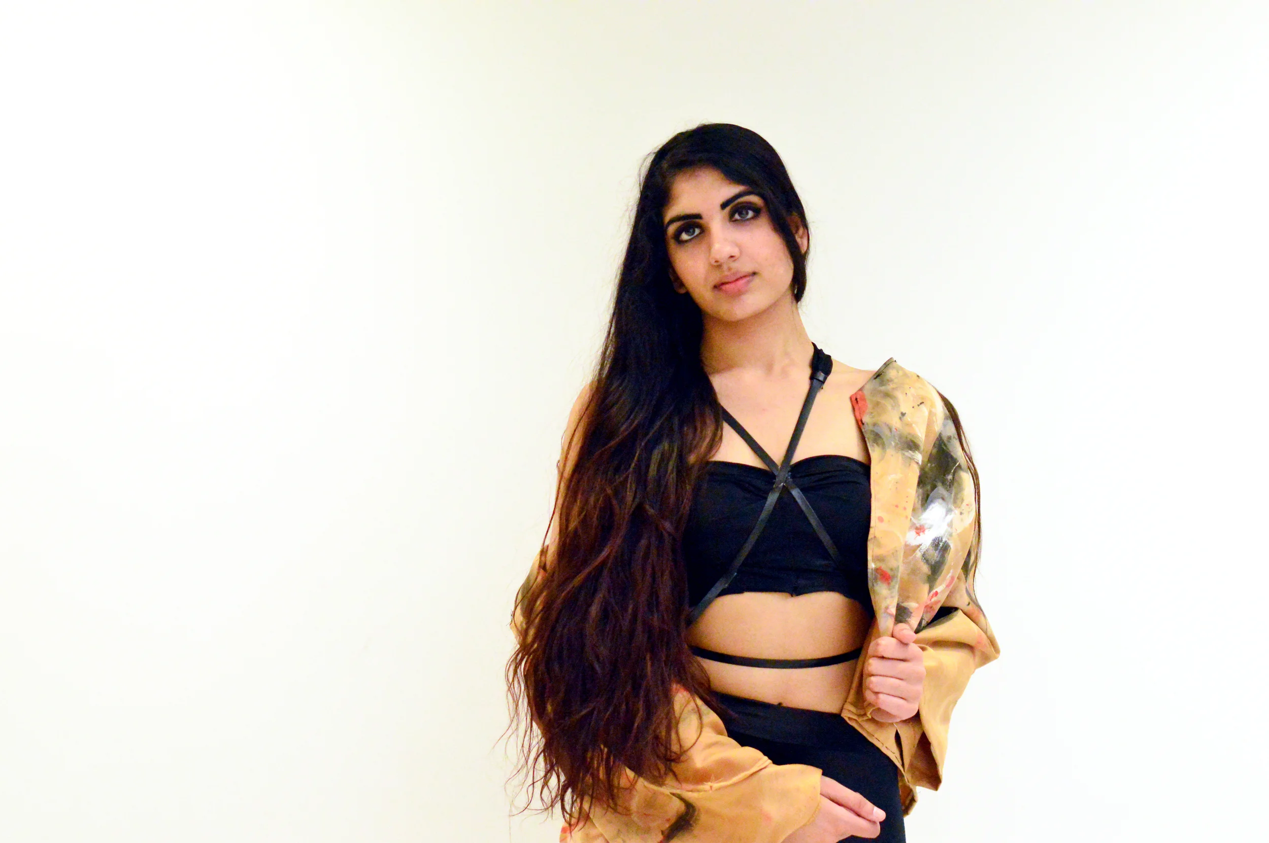  Top: Inspired by binding and sports bras. The back hooks together like a bra and the strap around the stomach connects with a hook in the back. Fabric used was black spandex along with leather straps.&nbsp;  Jacket: The jacket was a copper colored s