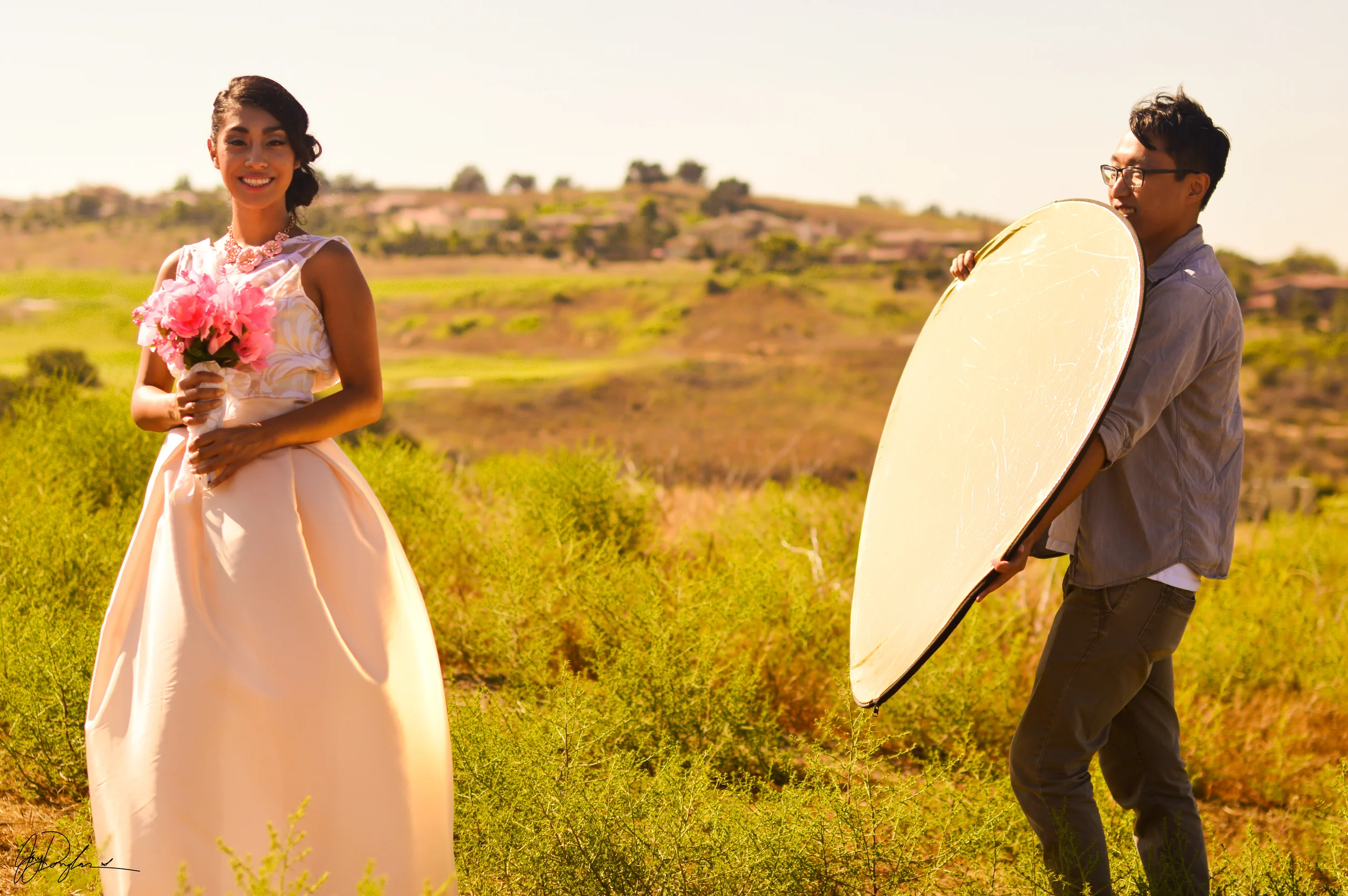 Model Yolanda Panuco and lighting assistant Darren Dai during an afternoon fashion wedding shoot. Chino Hills, California