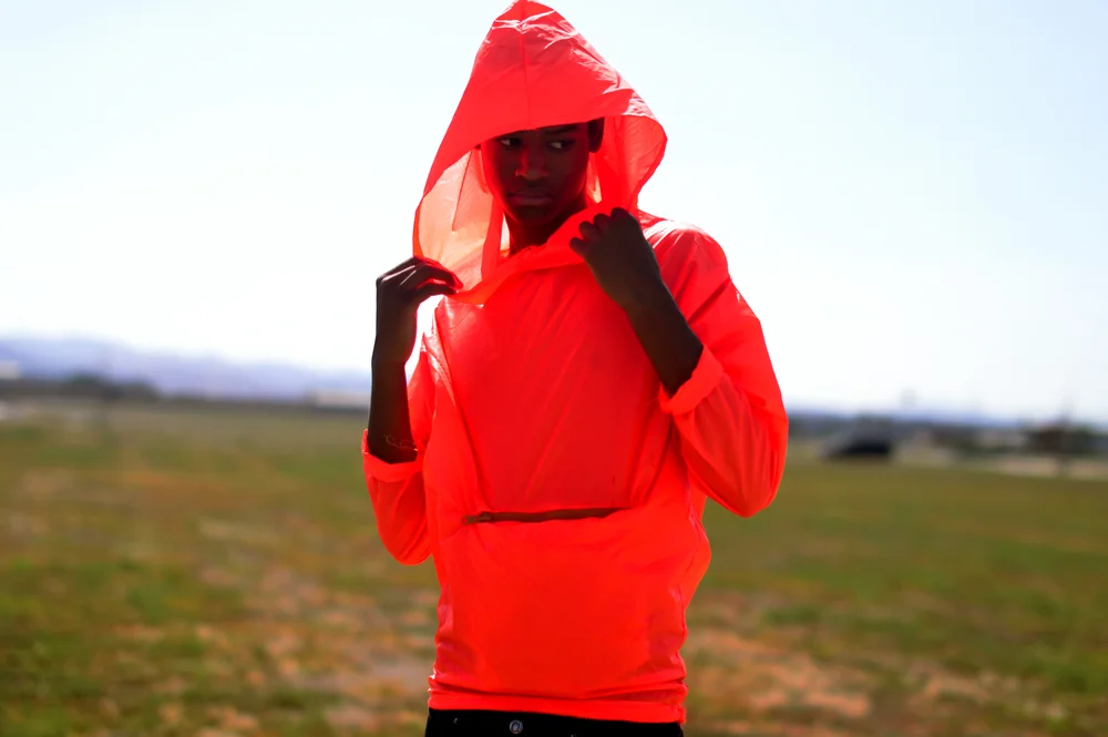  Waterproof Neon Orange hoodie. The hoodie transforms into a pouch with pockets by folding into it self.&nbsp;  The concept was to create an emergency hoodie. The color is very bright in any lighting which would allow someone lost to be found easily.