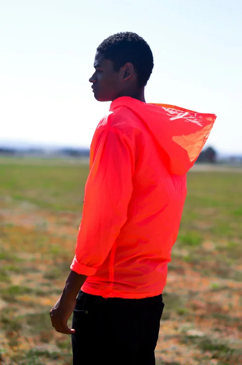  Waterproof Neon Orange hoodie. The hoodie transforms into a pouch with pockets by folding into it self.&nbsp;  The concept was to create an emergency hoodie. The color is very bright in any lighting which would allow someone lost to be found easily.