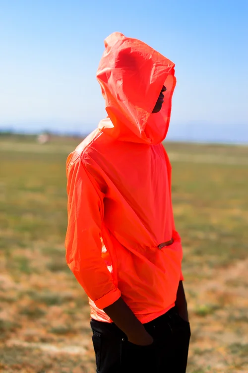  Waterproof Neon Orange hoodie. The hoodie transforms into a pouch with pockets by folding into it self.&nbsp;  The concept was to create an emergency hoodie. The color is very bright in any lighting which would allow someone lost to be found easily.