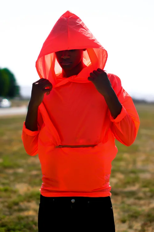  Waterproof Neon Orange hoodie. The hoodie transforms into a pouch with pockets by folding into it self.&nbsp;  The concept was to create an emergency hoodie. The color is very bright in any lighting which would allow someone lost to be found easily.