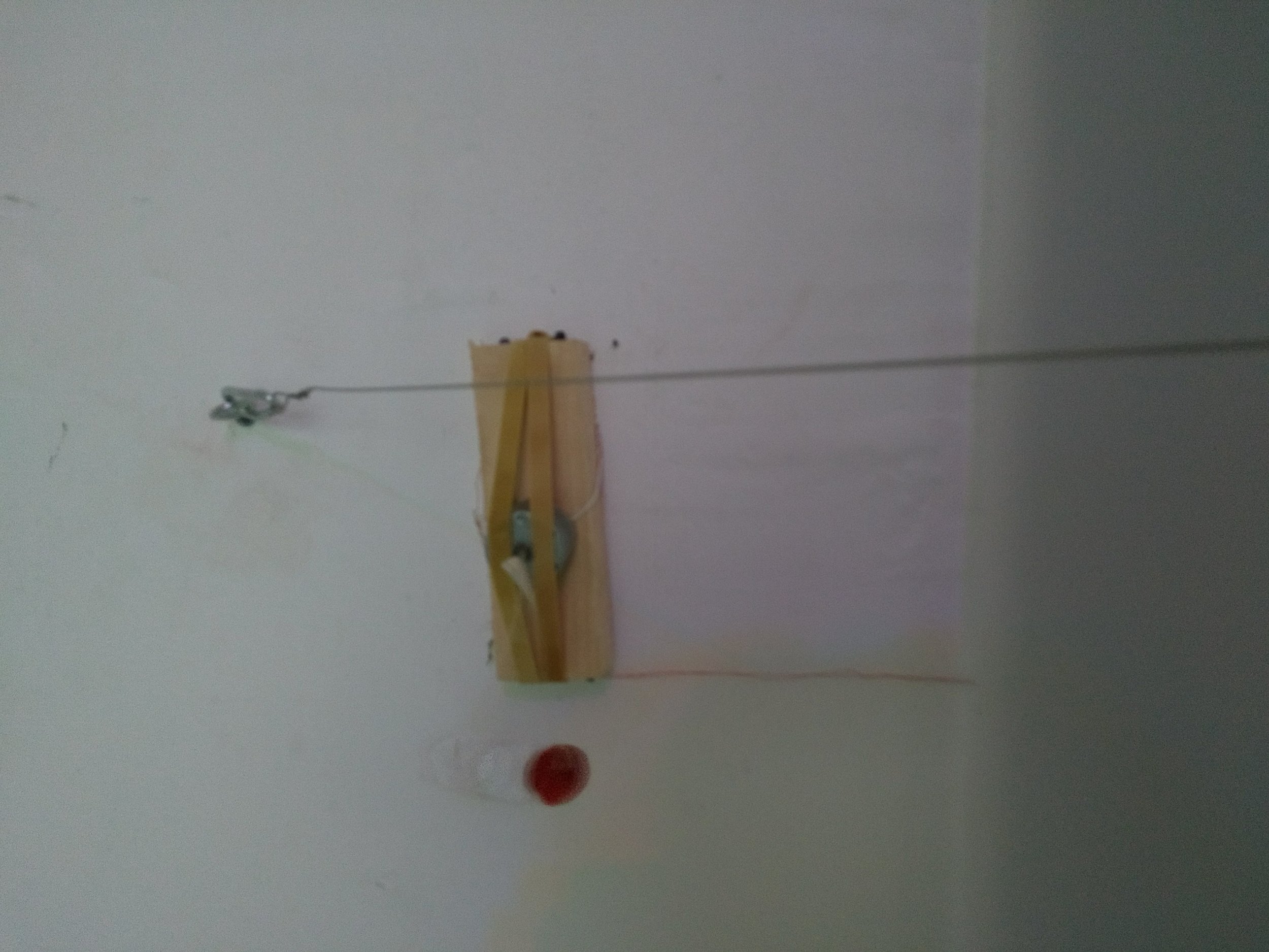  Detail of room 1: motion activated motor attached to found wood with rubber bands, found piano felt. 