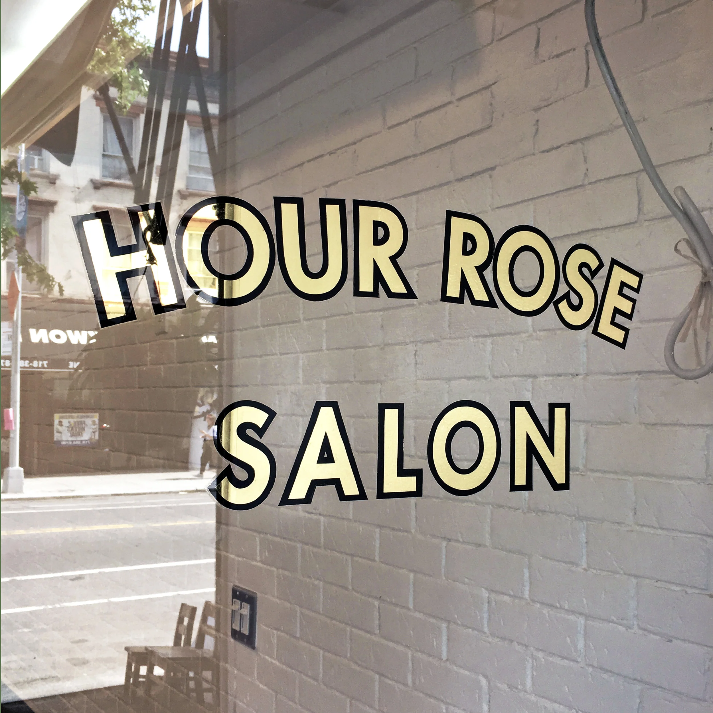 Hour Rose Salon - 23k Yellow Gold water Gilded logo with enamel outlines.