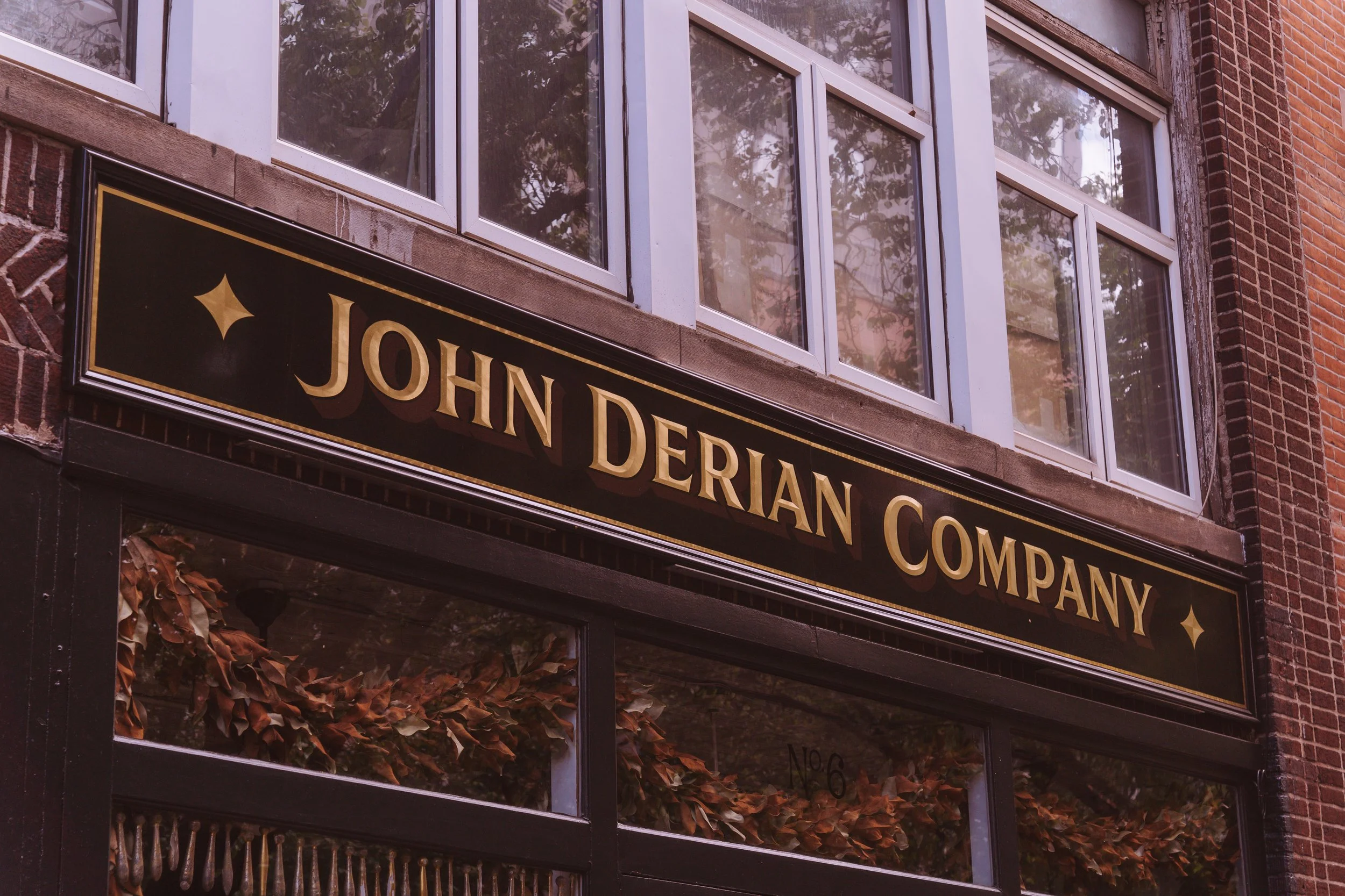 Hand painted and gilded exterior sign with 23k gold leaf and convex burnished letters for John Derian Co. in the East Village, NYC.