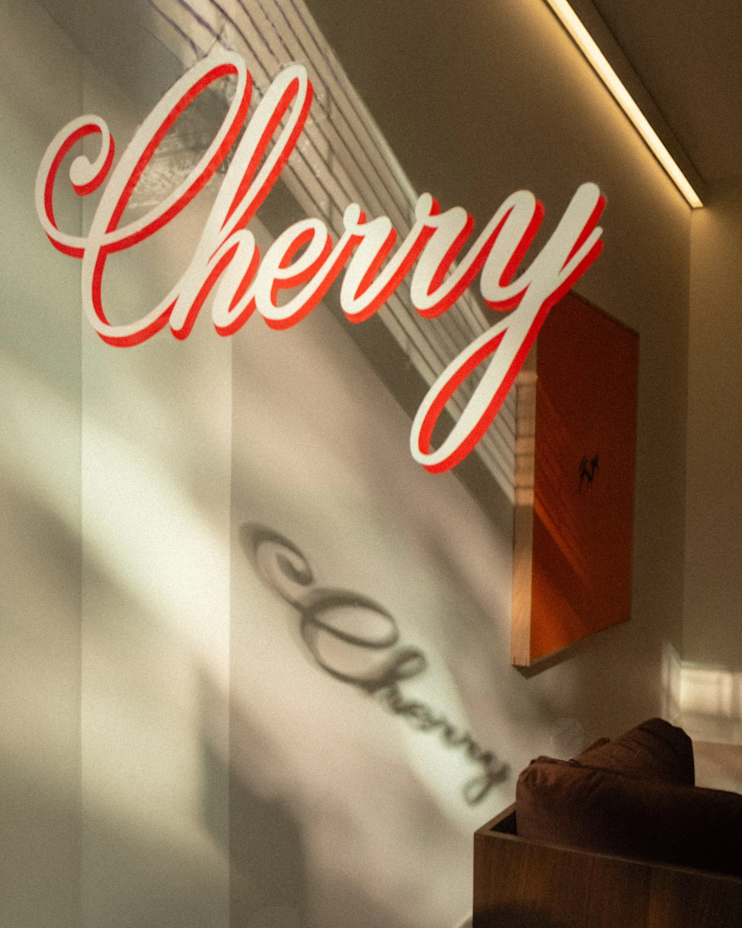 Hand painted sign on storefront window for Cherry LA pop-up shop in NY