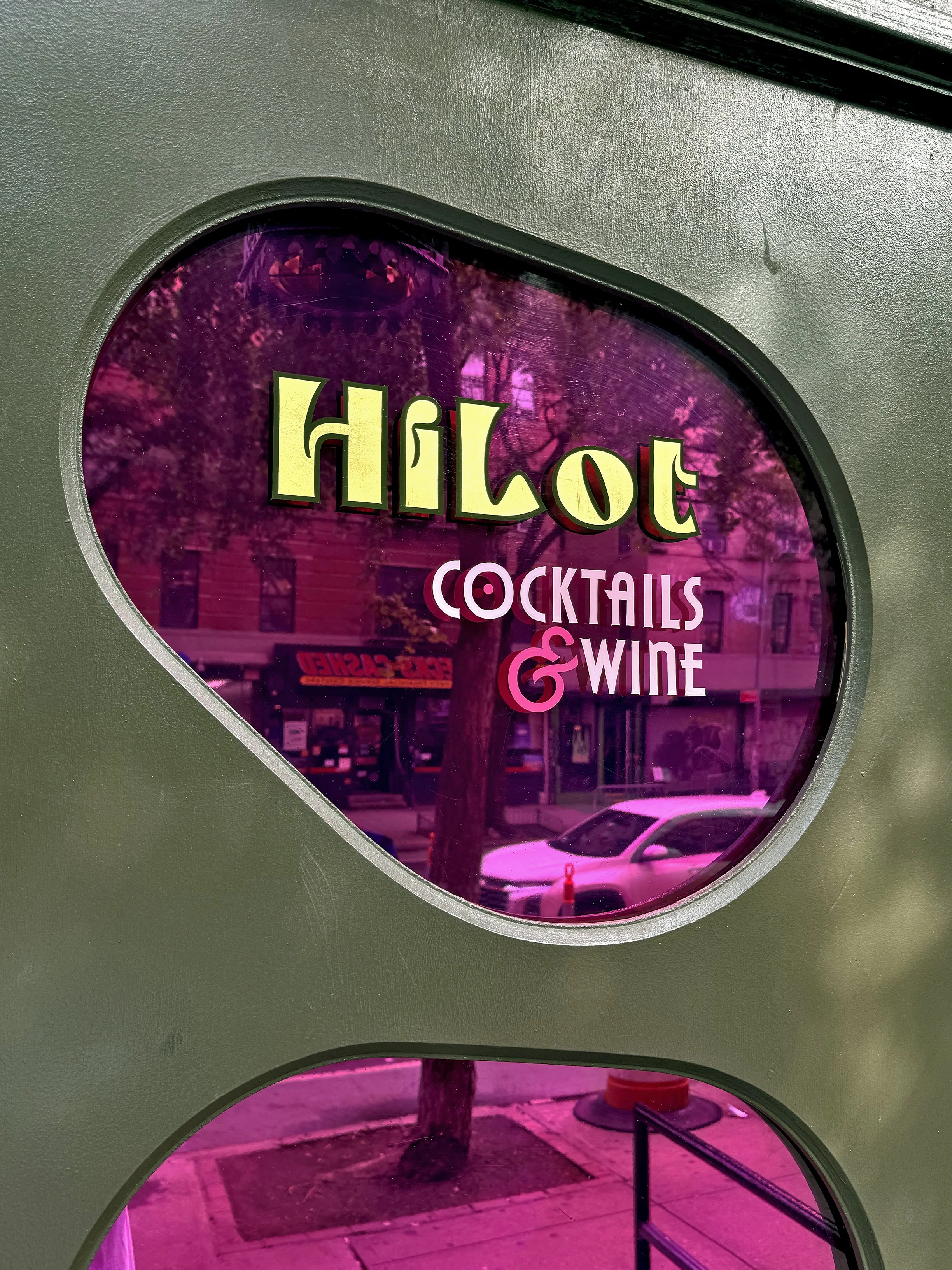 Gilded and hand painted sign using 23k gold leaf on front door window of bar HiLot.