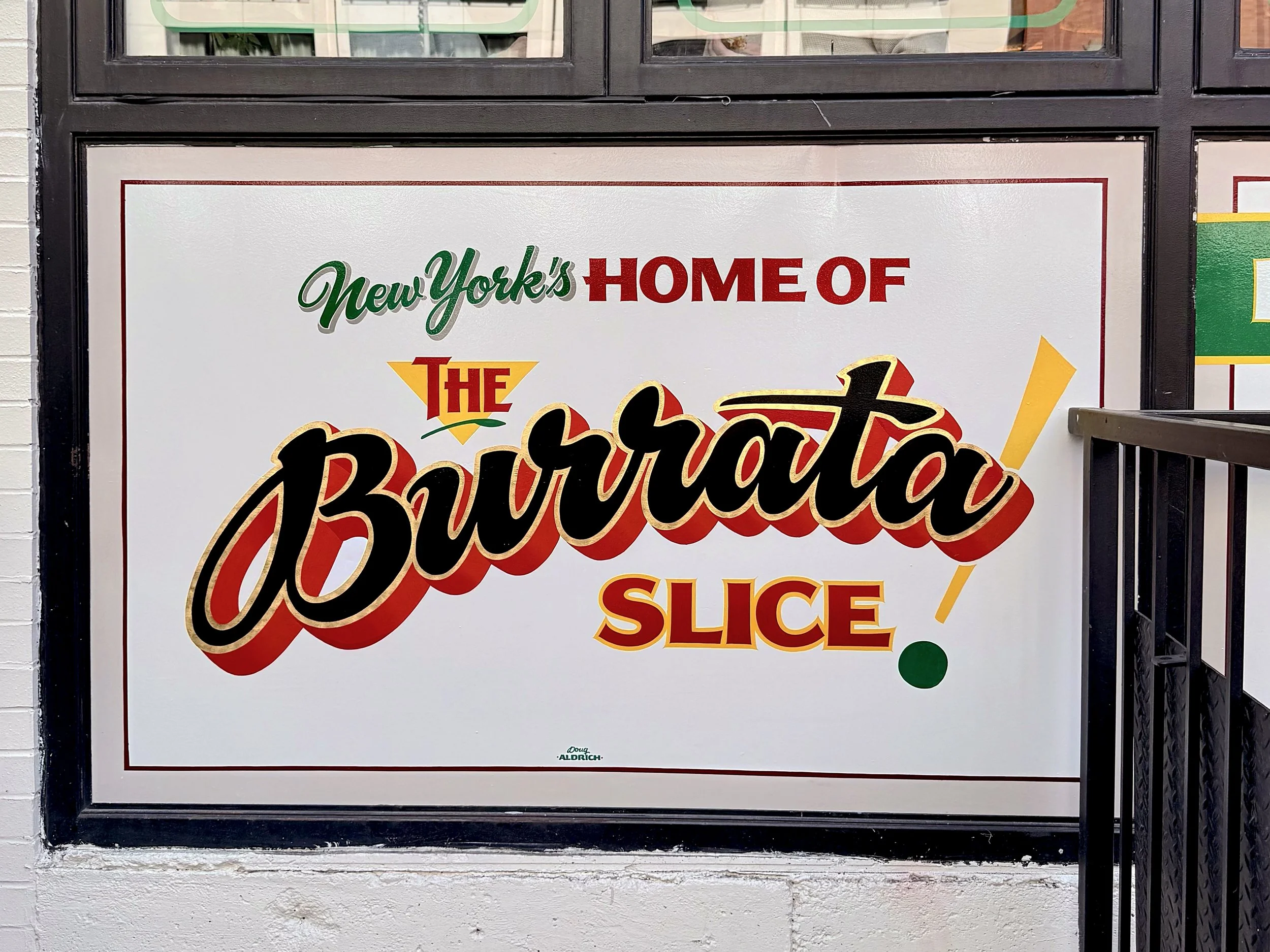 Hand painted sign with 23k gold leaf on exterior wall for L'industrie Pizzeria in Little Italy, NYC