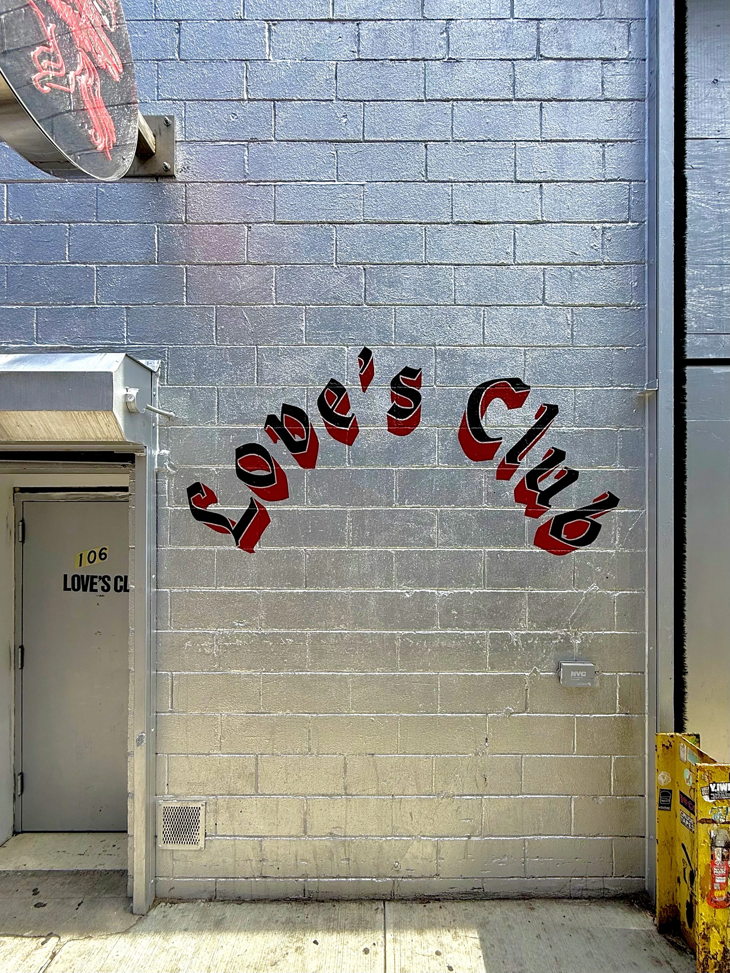 Hand painted sign on exterior brick wall for Love's Club in Brooklyn, NYC.