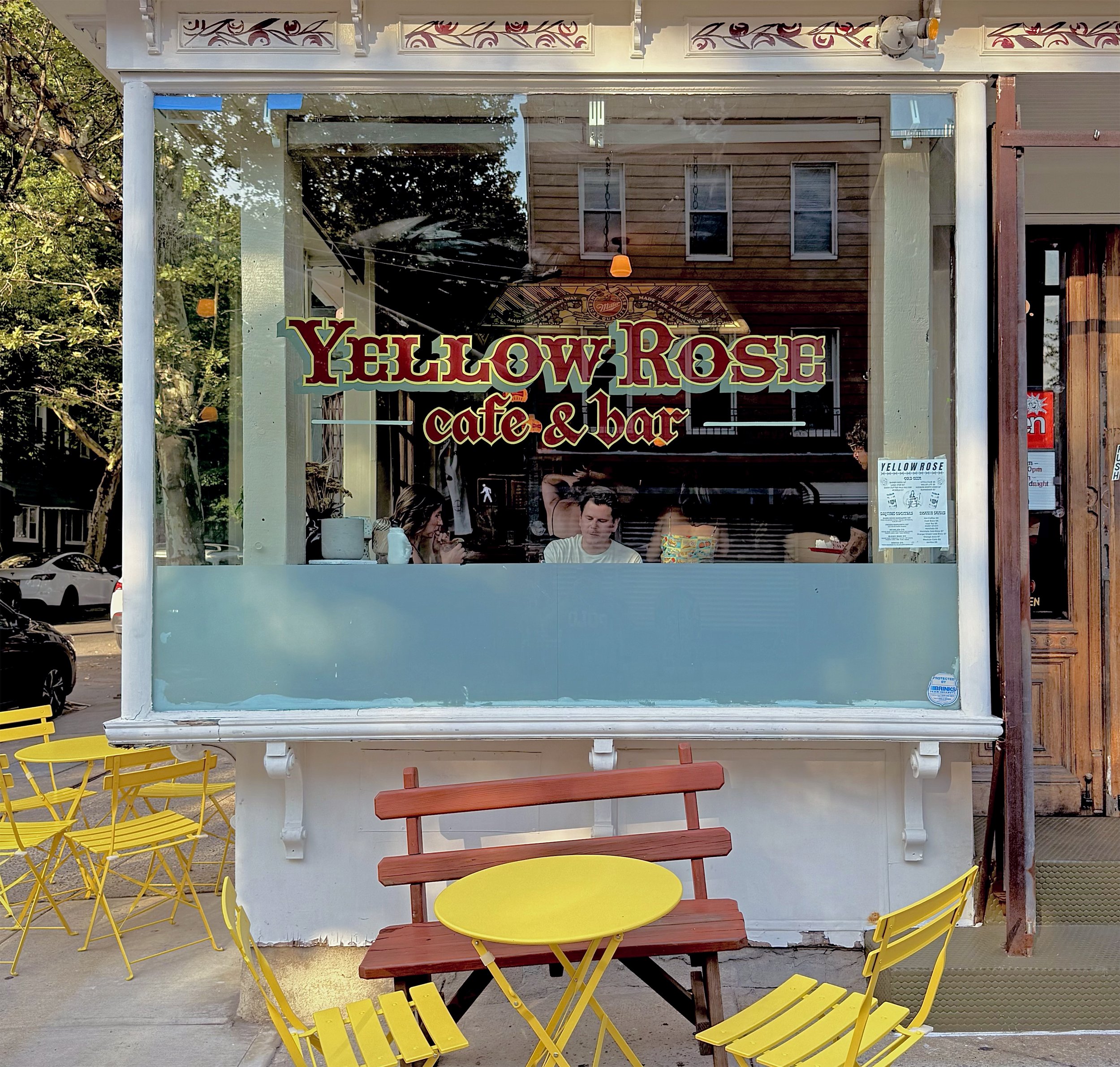 Hand painted storefront window for Yellow Rose in Brooklyn, NY