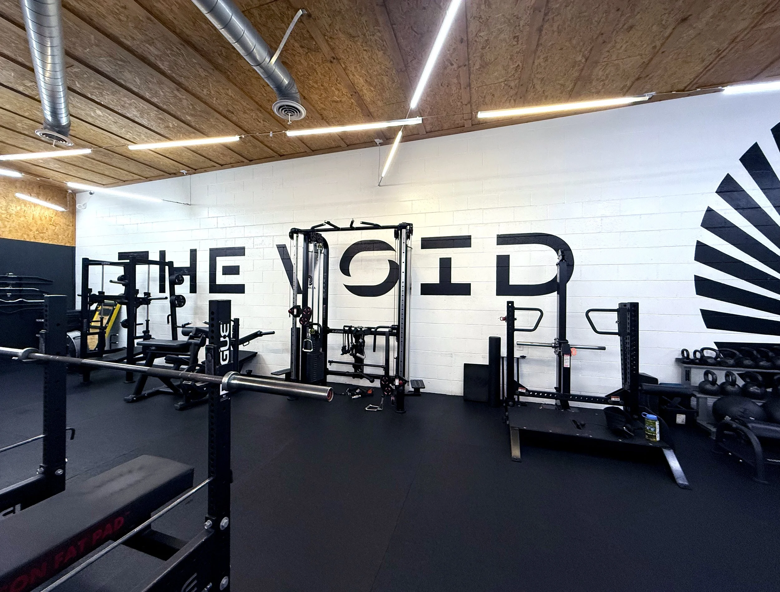 Hand painted logo on interior brick wall of fitness gym