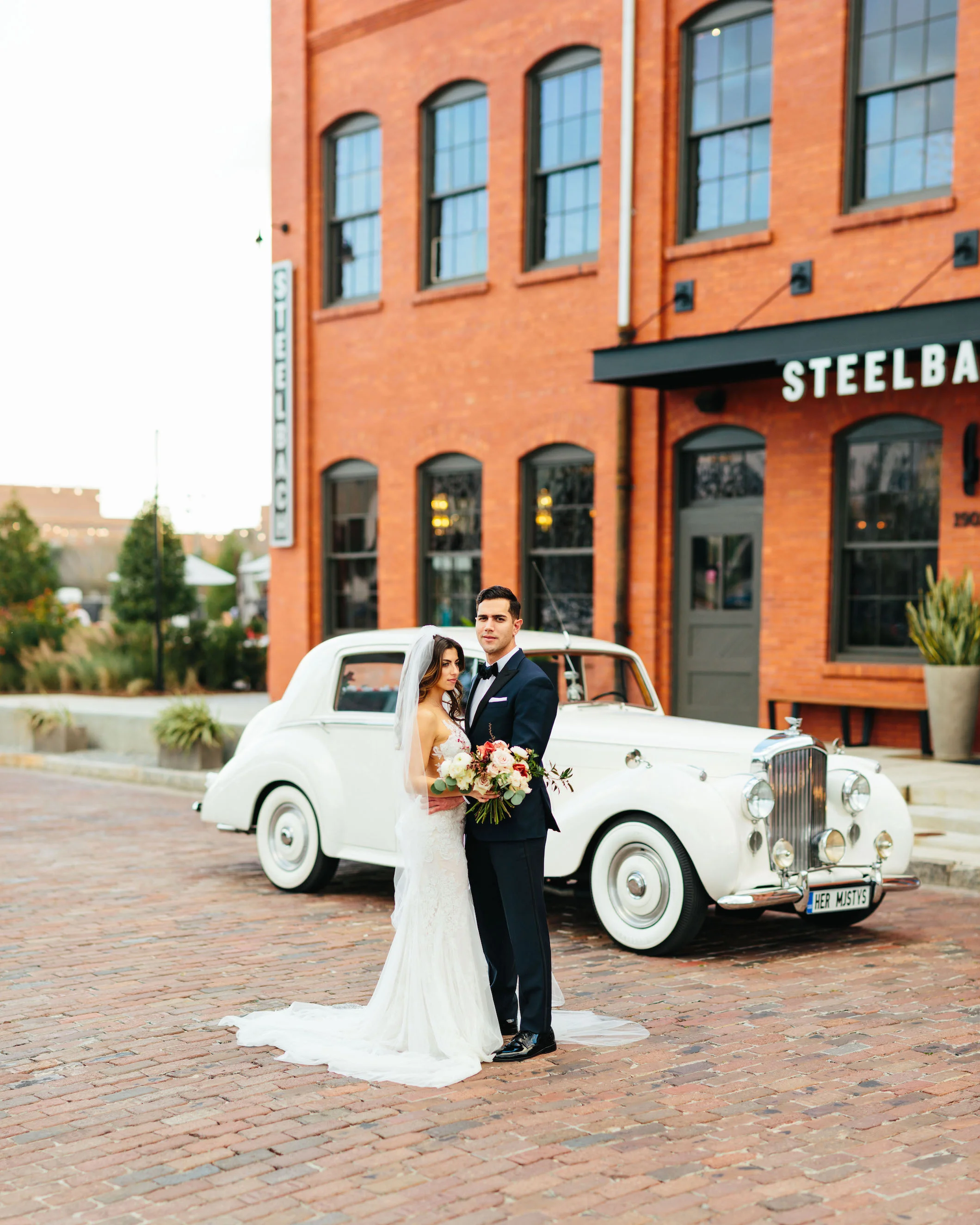 Bride and groom photo with Rolls Royce Armature Works Wedding