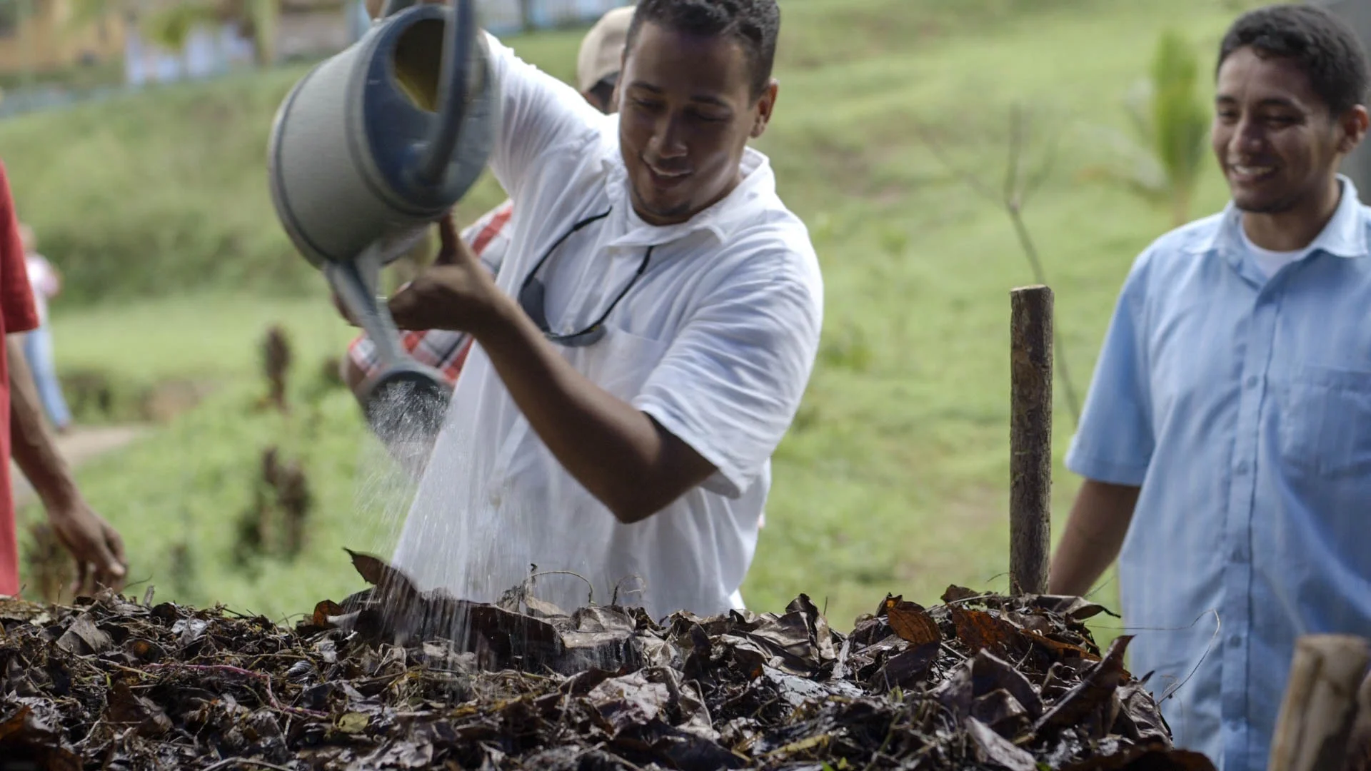 Watering compost, Biointensive training - video still, Tom