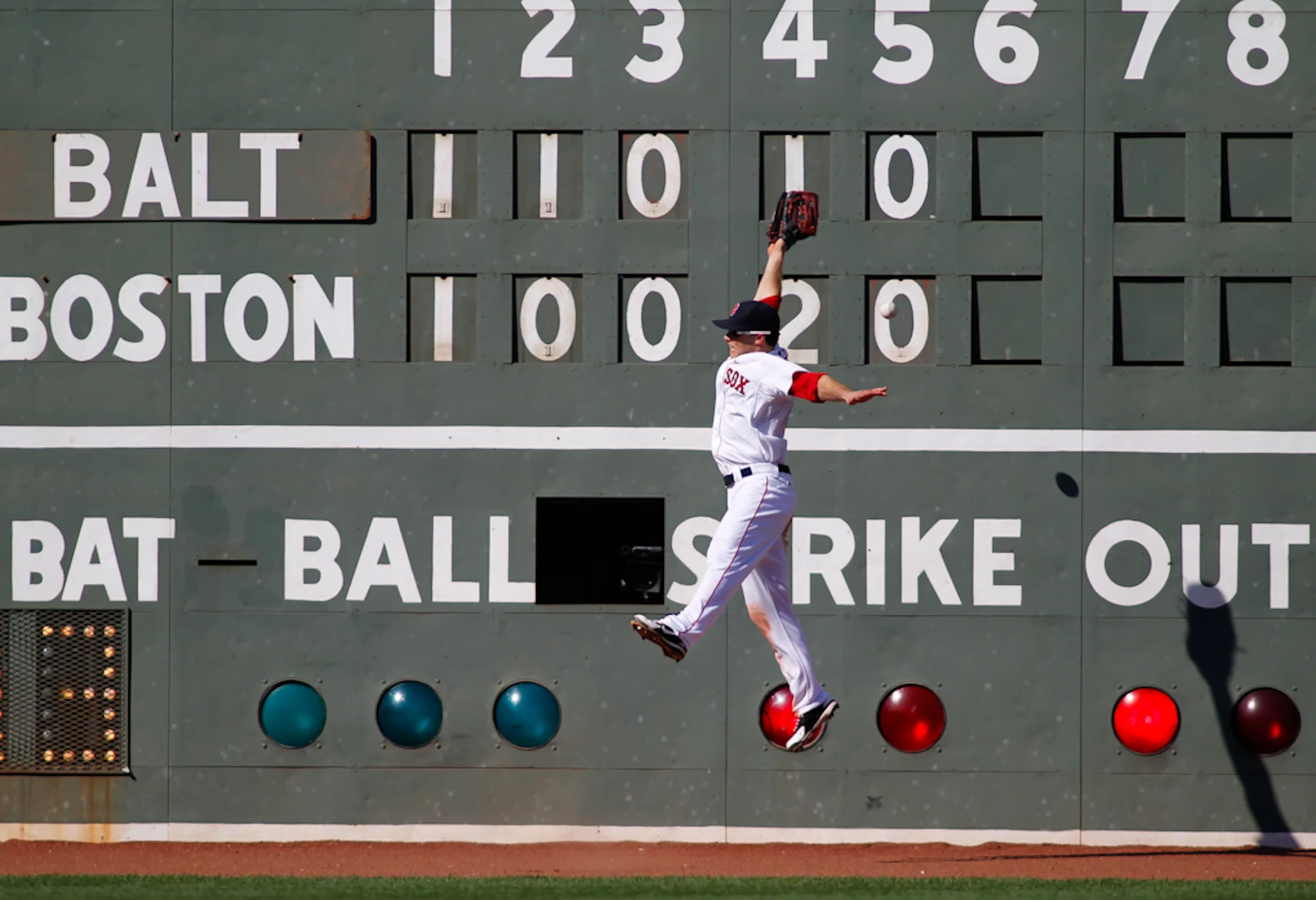 Boston Red Sox left fielder Daniel Nava leaps for a double hit by Baltimore Orioles batter Manny Machado in the sixth inning at Fenway Park in Boston on Saturday, September 22, 2012. 