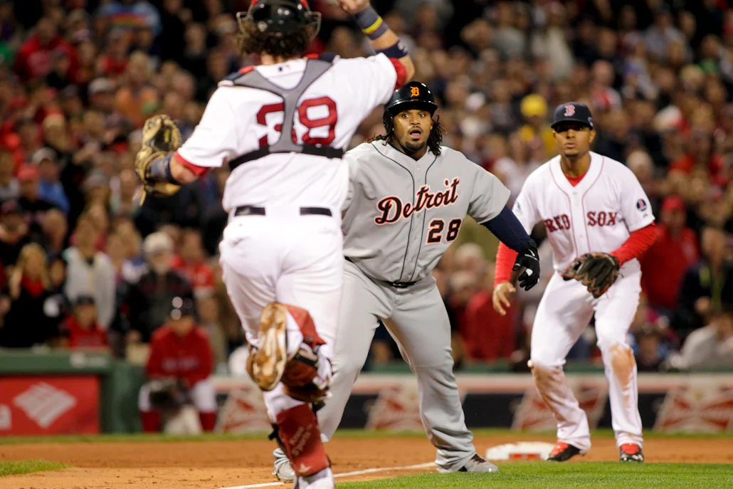 Detroit Tigers runner Prince Fielder (28) is chased down by Boston Red Sox catcher Jarrod Saltalamacchia (39) while third baseman Xander Bogaerts (72) waits at third base after Tigers batter Jhonny Peralta (not pictured ) grounded into a double play in the sixth inning of game six of the ALCS at Fenway Park in Boston on October 19, 2013. 