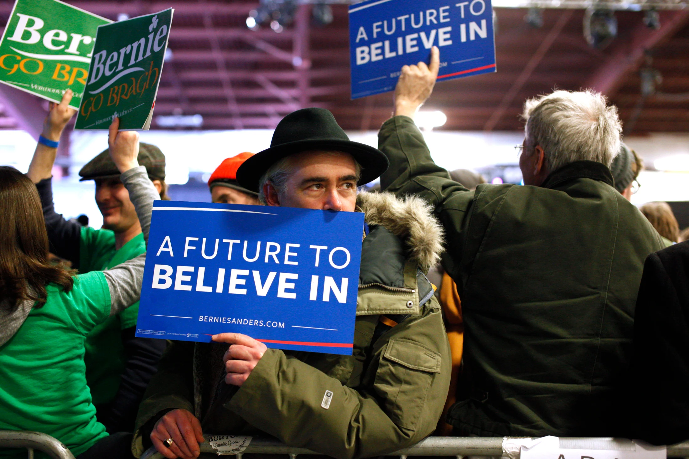 David Rosane, of Paris, holds a sign in support of Democratic presidential candidate Bernie Sanders, while waiting for the candidate to arrive for a Super Tuesday rally at the Champlain Valley Exposition in Essex Junction, Vermont on March 1, 2016. Rosane cast an absentee ballot from Paris but flew back to Vermont recently to attend the rally.