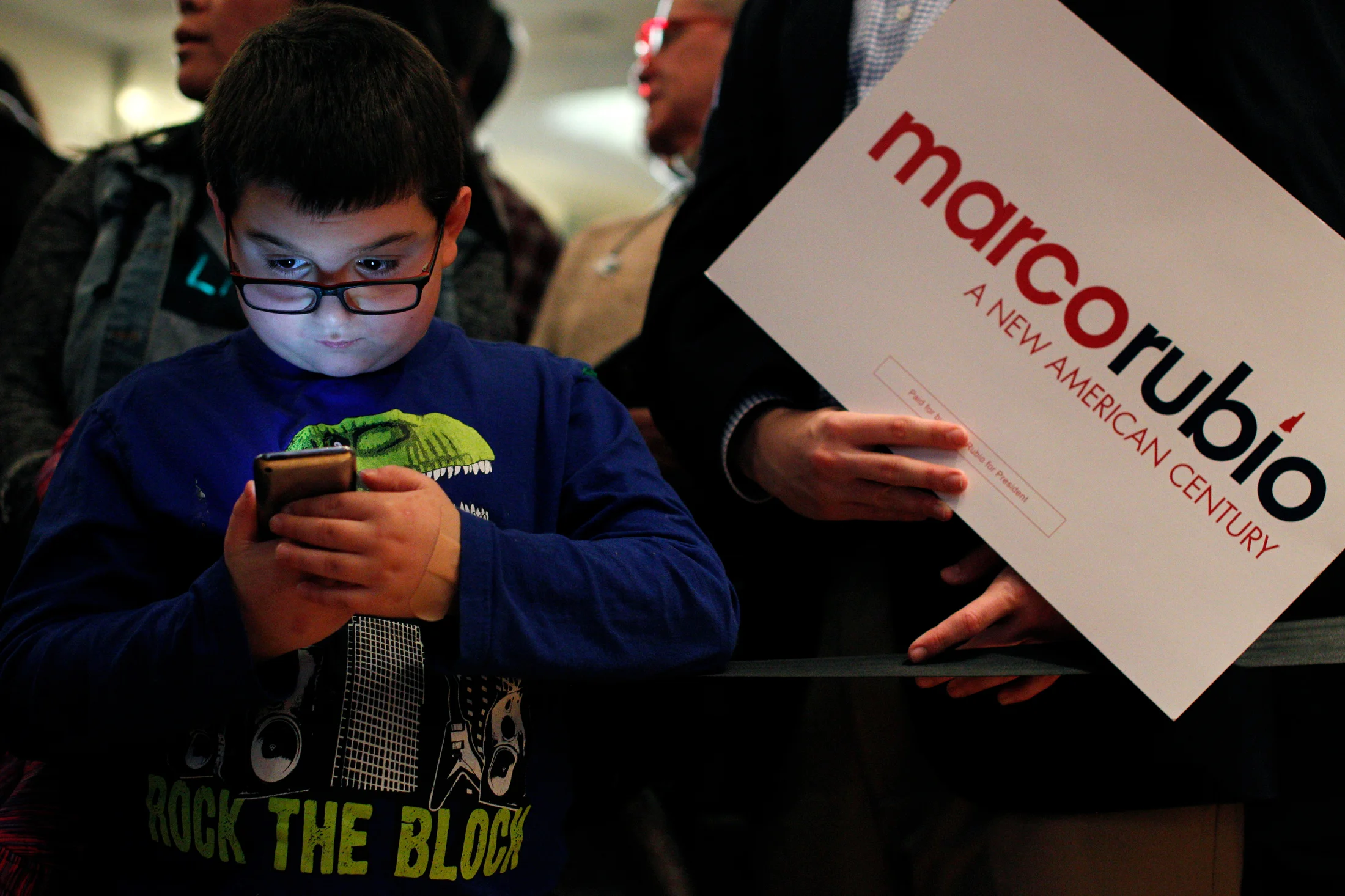Mark Mooers, 9 of Manchester, New Hampshire, plays a game on his iPod while waiting with his family at a primary night watch party for Republican candidate for president Marco Rubio at the Radisson in Manchester, New Hampshire on February 9, 2016. Early results showed Rubio finishing in fifth place in the nations first Presidential Primary.