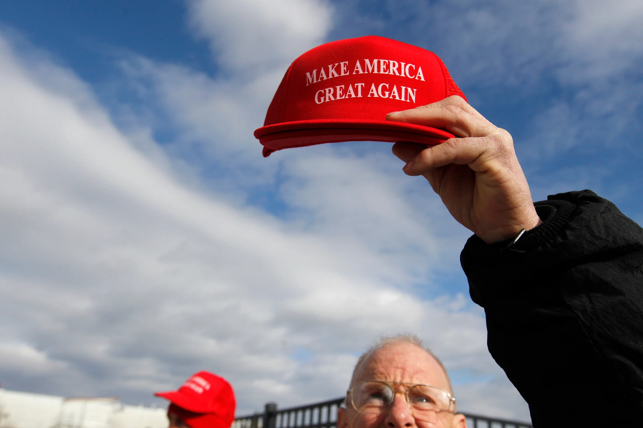 Robert Binington of Sarasota, Florida holds up a 'Make America Great Again' hat while selling paraphernalia in support of Republican candidate for president Donald Trump prior to a rally for Trump at Plymouth State University ALLWell North in Holderness, New Hampshire on February 7, 2016. New Hampshire will hold the first primary in the country on February 9th.