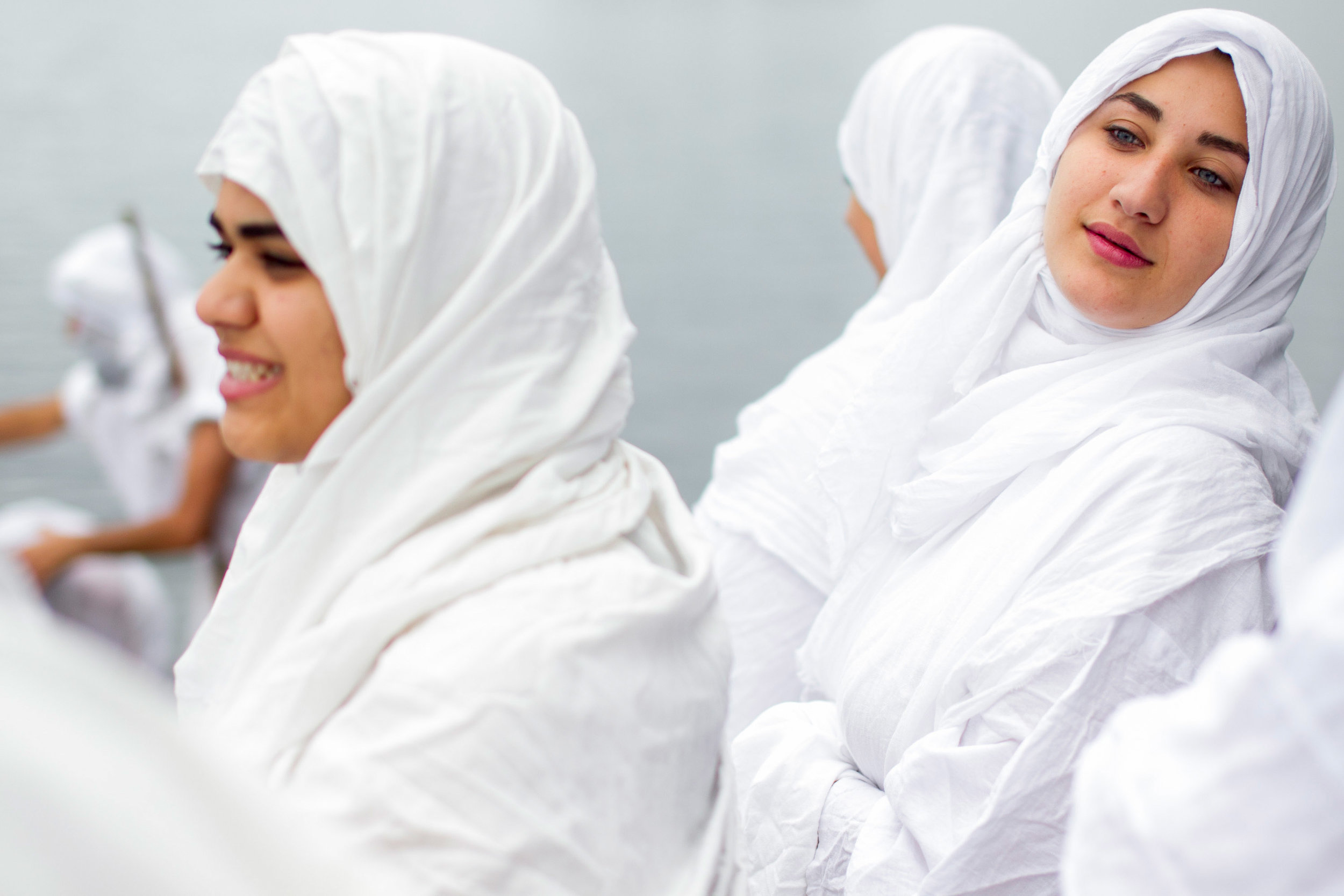 Maysam Alzuhairi (R) of Worcester and Awham Alkuheli (L) of Worcester wait their turn to be baptized at a Mandaean baptism ceremony prior to a wedding celebration on the banks of Lake Quinsigamond at Lake Park in Worcester, Massachusetts on July 10, 2016.
