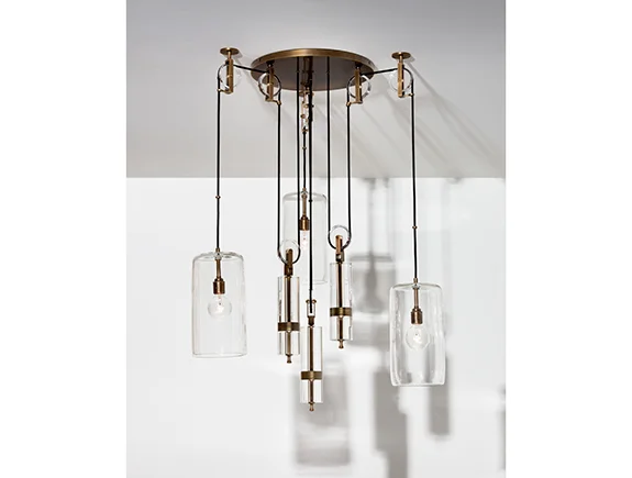 Alison Berger's Counterweight chandelier is inspired by Galileo's gravitational pulley studies from the 1600s. With a series of wheels and weights all the pendants can be raised and lowered to emphasize movement. I love the lightness of the clear glass shades and the Edison-style bulbs, also the rubbed bronze is my current favorite metal finish. From Holly Hun t Hollyhunt.com
