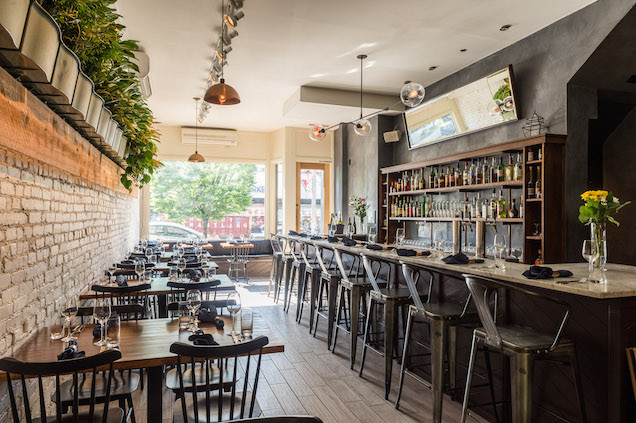 In true rustic Brooklyn tradition there's the exposed brick walls, bleached wood floors and Edison bulbs. The living wall of plants is a nice addition