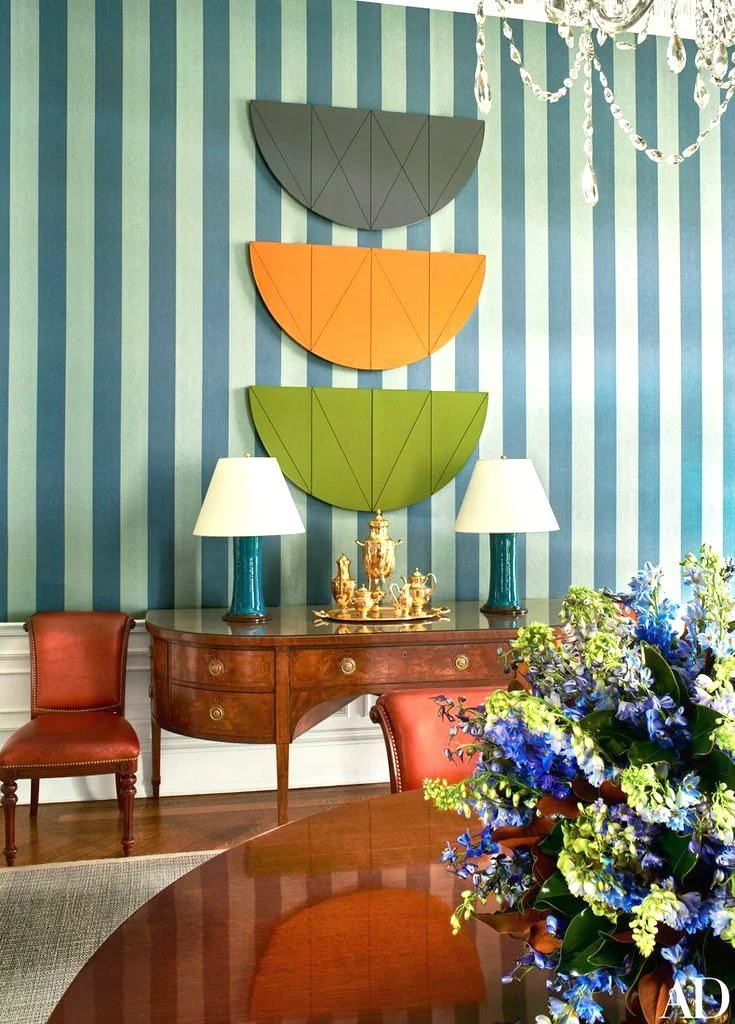 A dynamic Robert Mangold artwork offsets the formality of the circa 1800s antique sideboard
