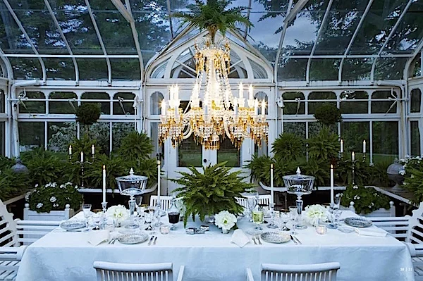 This very elegant high impact vignette created with a classic chandelier and crystal from Baccarat - the simple backdrop of green and white is spectacular! Carolyne Roehm at Weatherstone , her home in Connecticut - photography by Sylvie Becquet