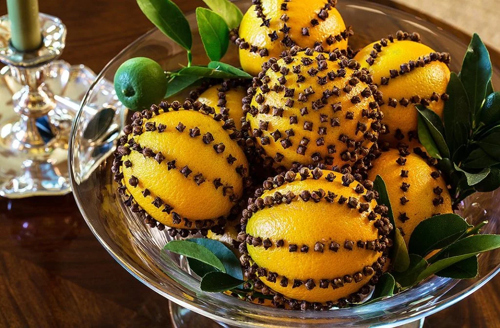 Suzanne Rheinstein brings her Southern-style charm to Christmas decor, mixing flourishes of greenery and citrus...oranges studded with cloves set in a crystal bowl make a simple yet elegant statement