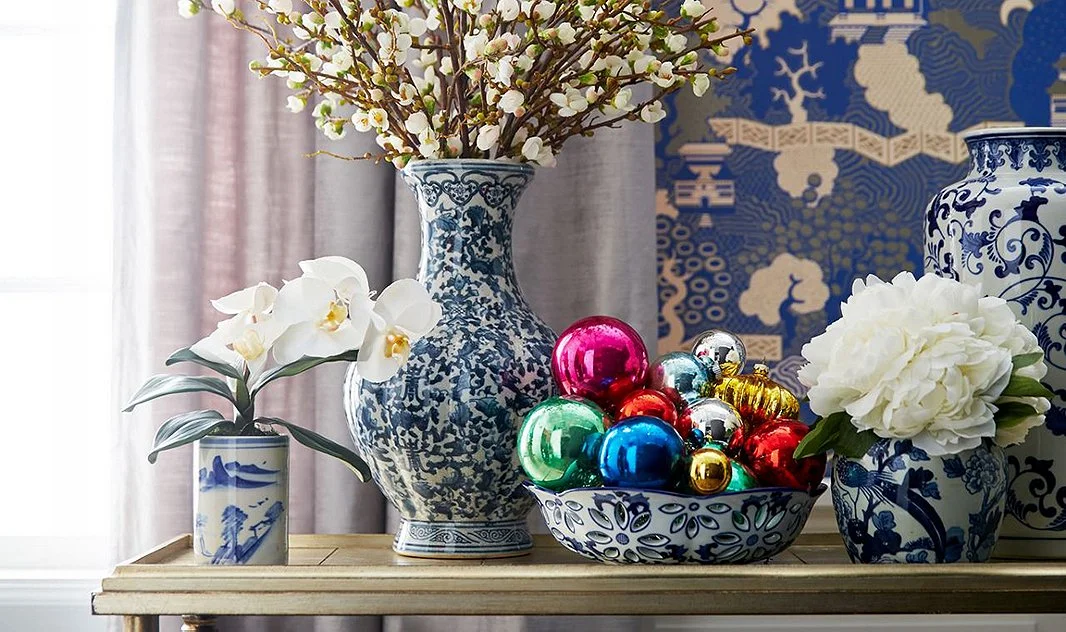 Loving this mix of chinoiserie, delicate white florals cut low and shiny orbs in a bowl for the perfect vignette - One Kings Lane