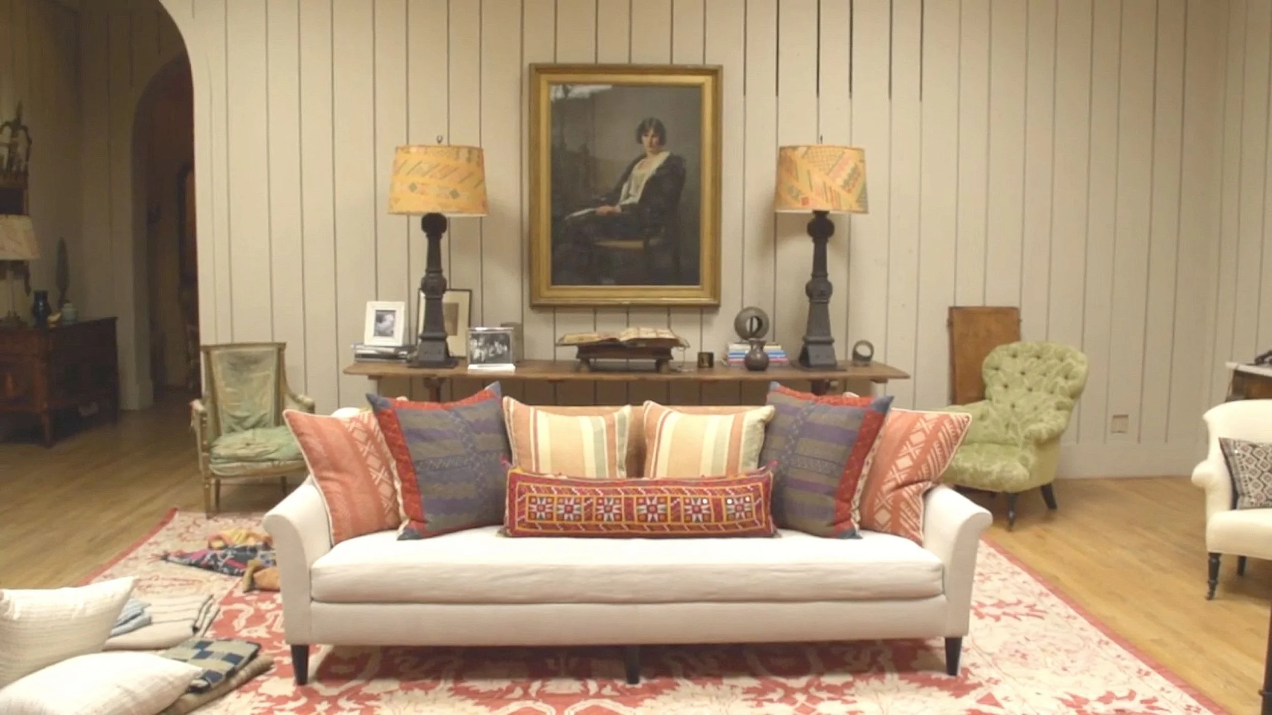 Kathryn then begins to add cushions - to maintain the right scale, balance and proportions, the largest 24" cushions are placed on either end to anchor the sofa and smaller 21" cushions are then grouped together, with a bolster placed in front. What I like about this arrangement is that 5 different textiles are used in combination, tied together with similar shades of sienna running through all the fabrics. The bolster has the same shade of embroidered thread woven in the fabric. Although the bolster completes the look, it's probably the one that will be jettisoned so you can sit and get really comfortable.