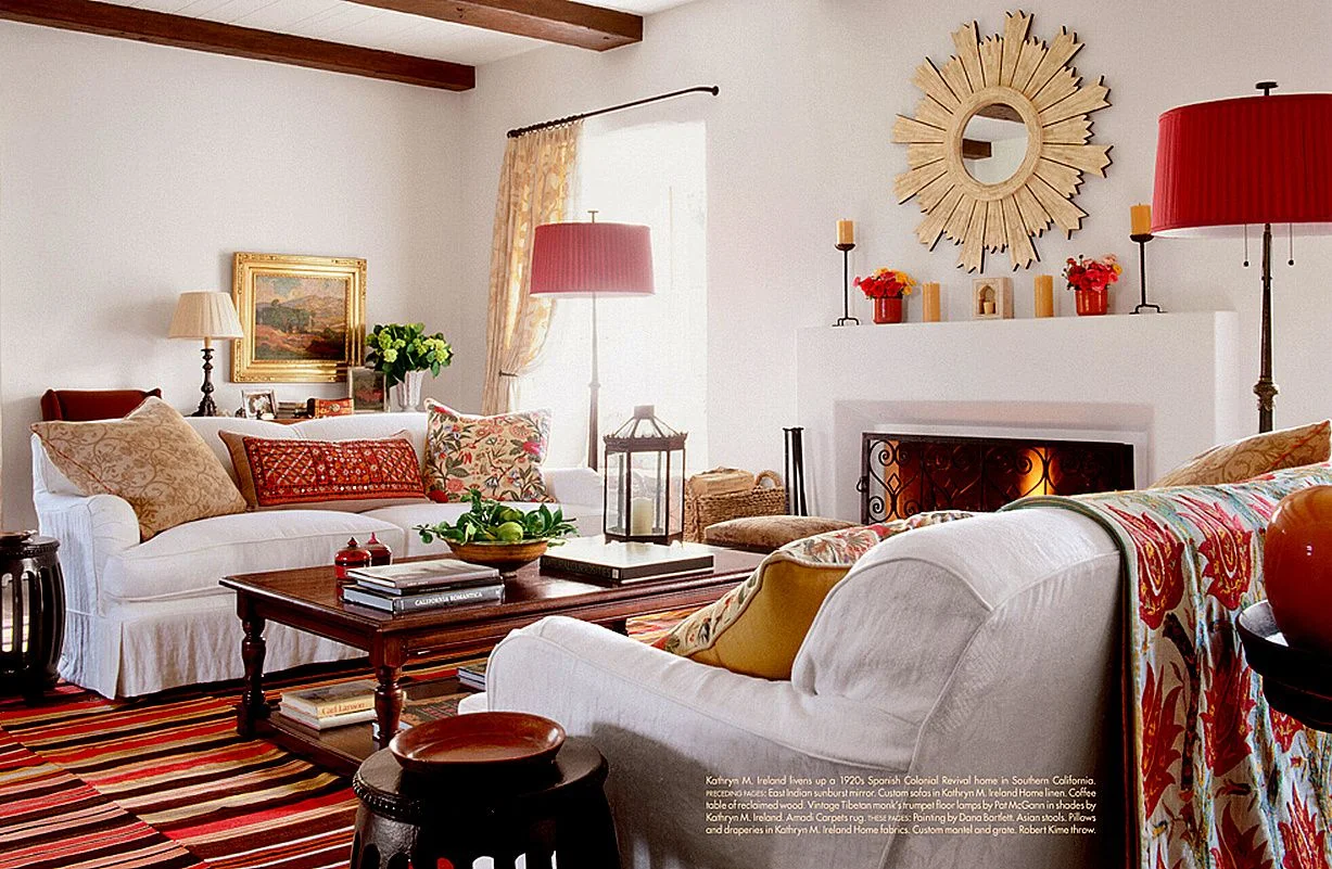 To bring instant individuality and style to your living room seek out unusual and/or vintage fabrics that can be made into cushions and throws. Using one dominant color throughout will pull the whole look together - as you can see here complementary shades of red do the trick!