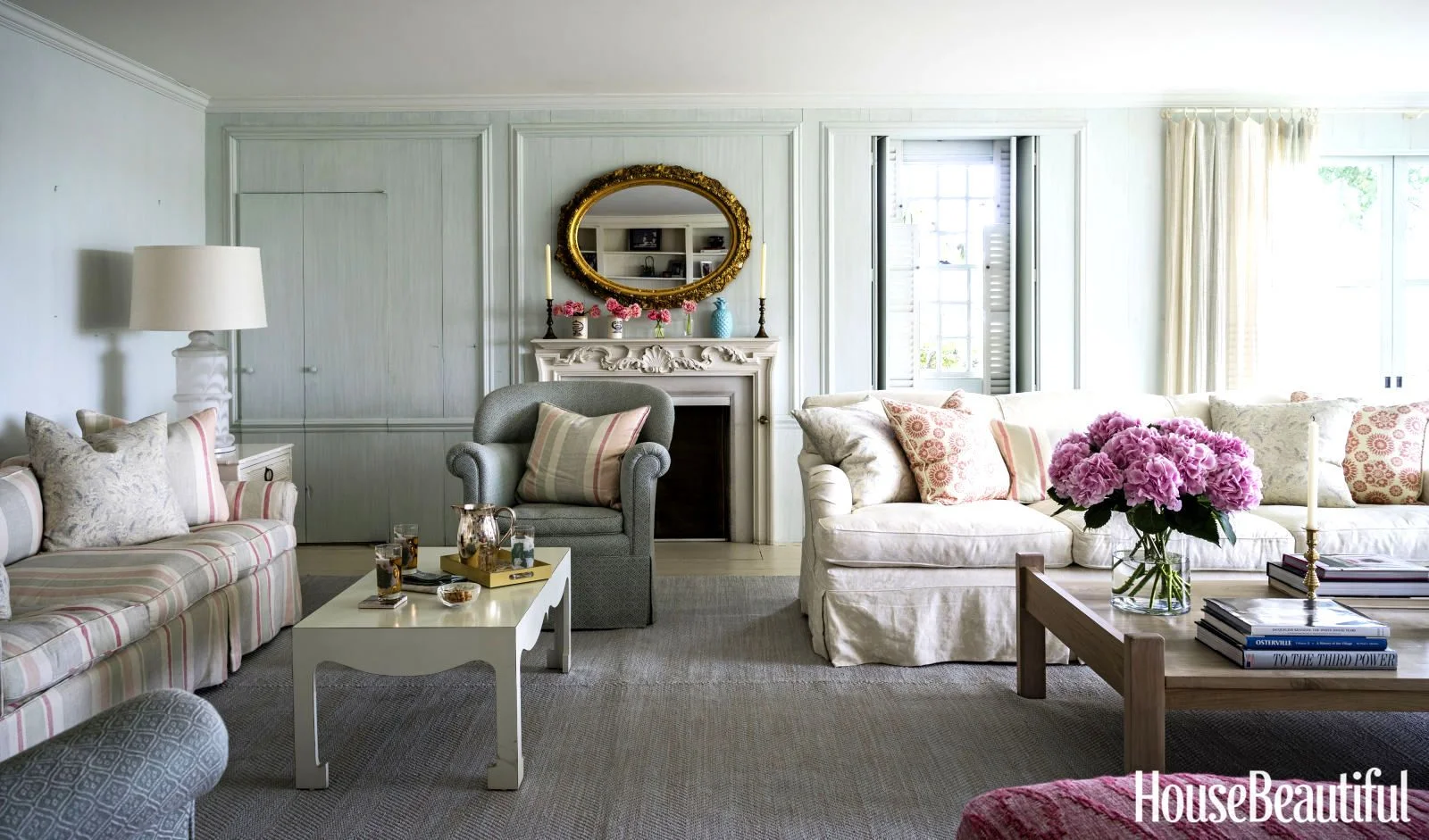 The grey painted walls makes this room look less cottage-y than Kathryn's typical style, but still has a very relaxed vibe enhanced by an abundance of cushions and loose sofa covers.
