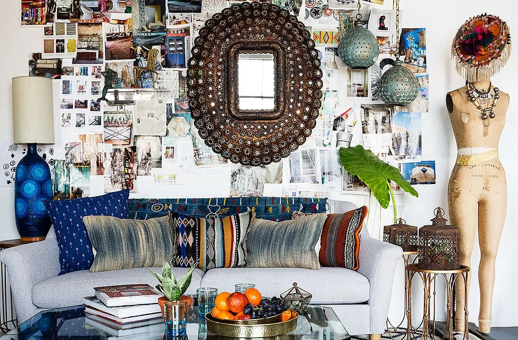 Photo by Nicole LaMotte; studio of Justina Blakeney This eclectic look is like an art installation with the layers of photos, mirror, objets and the pillow grouping on the sofa...it's busy but feels very personal