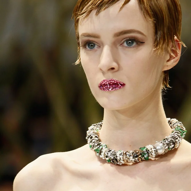 Christian Dior Spring 2013 Couture Long before McGrath sparked the glittery lip trend with her Lust 004 kit , she was topping the lips at Dior Couture with red-and-pink Swarovski crystals. Allure Magazine: Photography - Julian M Hekemian