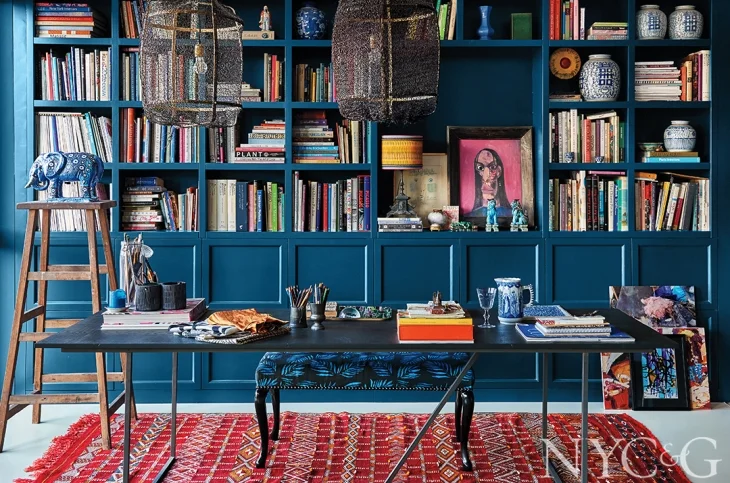 Blue and red is probably my favorite color combination for interiors, especially when my intention is to bring warmth and intimacy to the space…I have a red and blue media room which no-one ever wants to leave due to its high cozy factor...in Mariska’s workspace the bookcase continues the Farrow & Ball Hague Blue theme, giving the shelves high visual impact - you can remove a book without ruining the entire look…just love the porcelain elephant sitting on the ladder - I’m assuming no small children live here