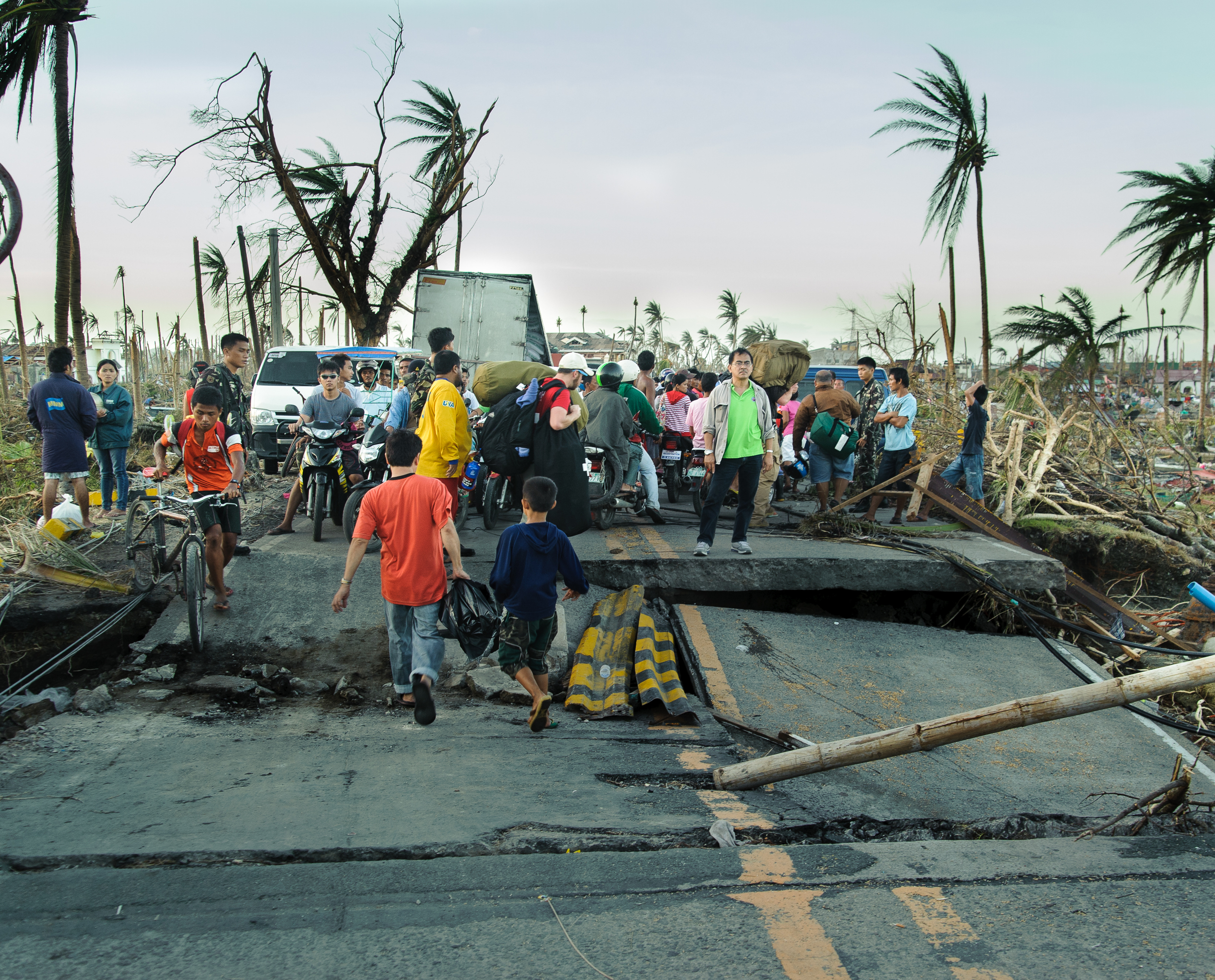 Team members and local residents must navigate their way over fallen electrical lines and roads destroyed by the storm as they approach the town from the south.