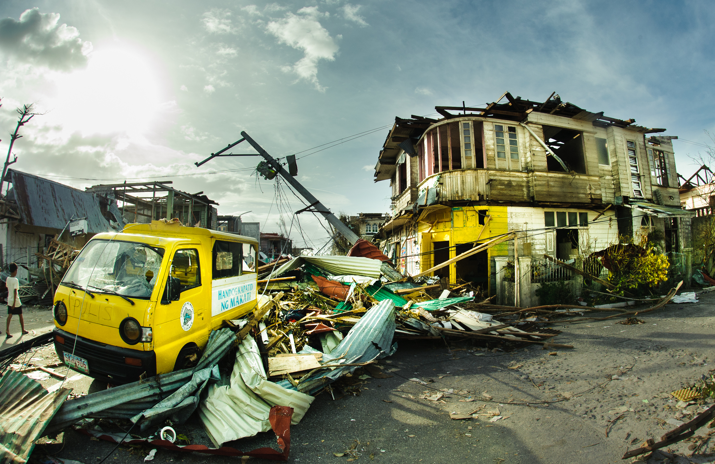 The trajectory of storm debris swept in by the storm surge comes to rest against a police van at the town center. Most of the local police force was lost in the typhoon after police were deployed by state authorities during the storm to prevent loot