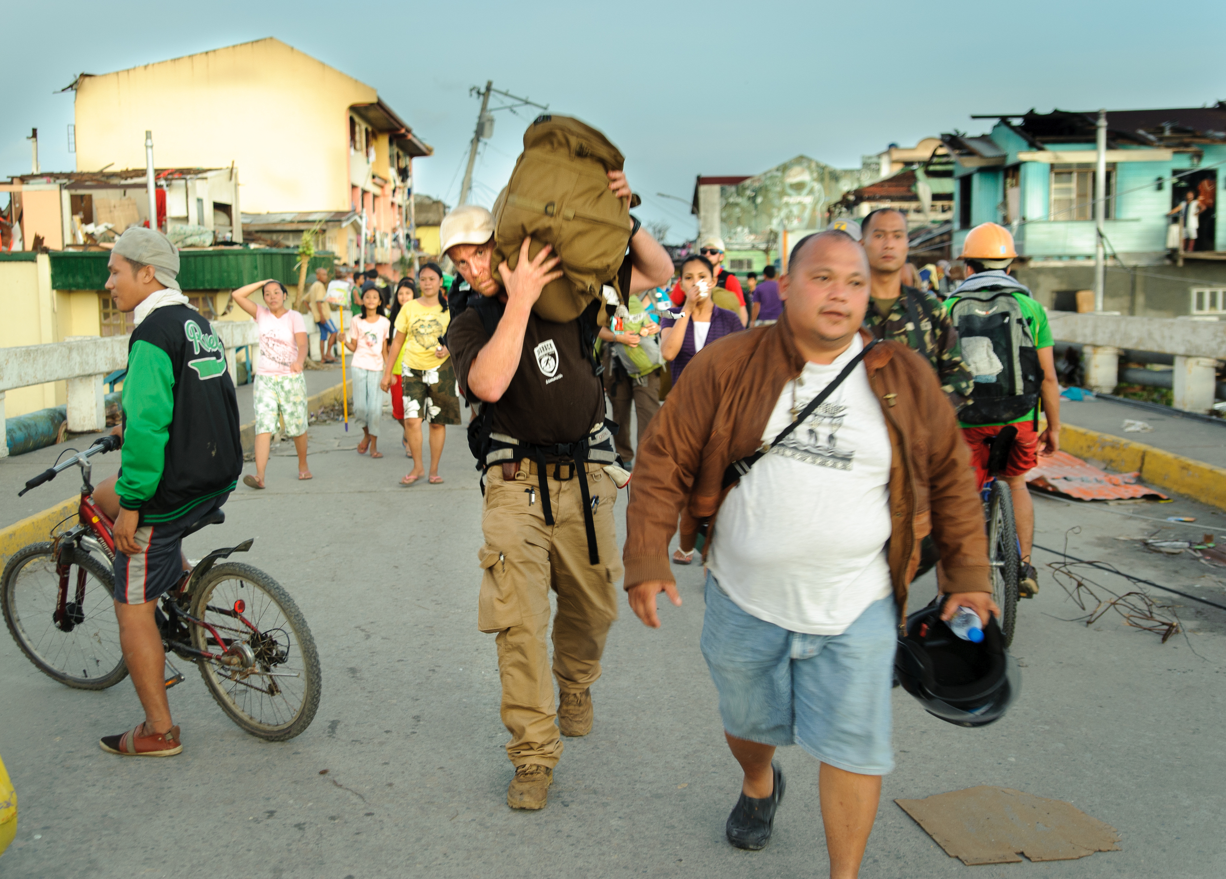 As dusk falls, the team, led by Dr. Michael Karch and accompanied by residents anxious for medical care, hoists their gear on their backs and begins the nearly 2 mile hike into town.