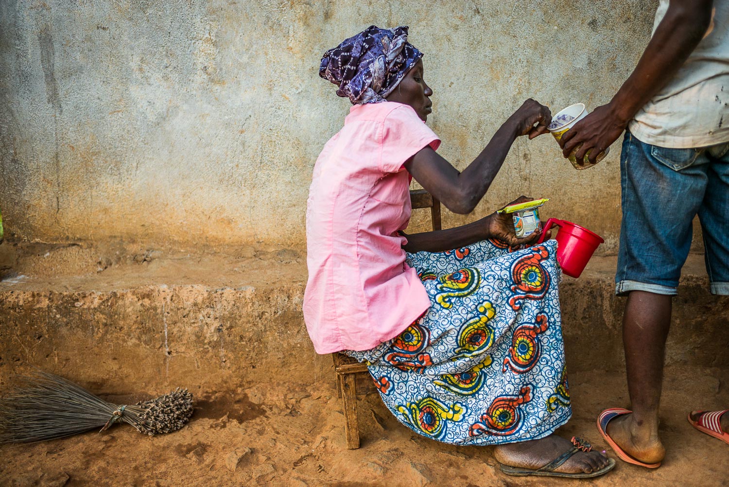 April 2017. Eye's son Earnest tries to coax his mother to eat. Weakened by illness, Eye is no longer strong enough to prepare meals. She has been unable to eat the standard rice meal for the past several weeks, due to a combination of difficulty swa