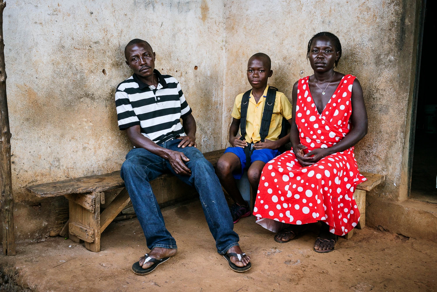 November 2015. A portrait of Francis with his uncle Matthew and aunt Eye in front of their home.