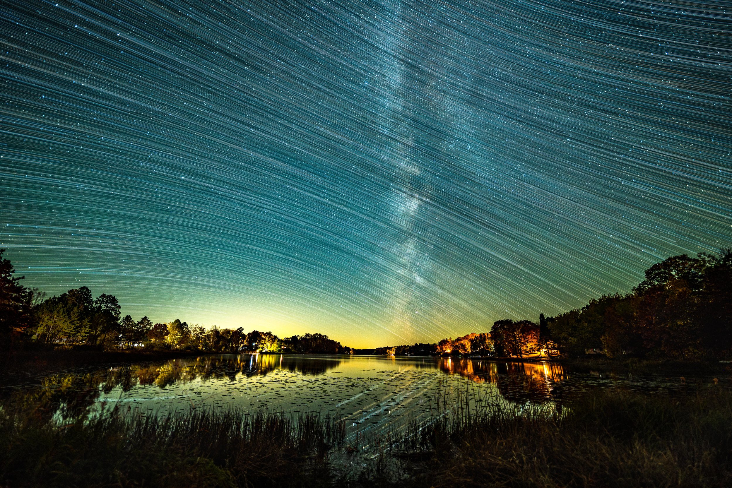  The Milky Way and star trails above a secluded lake in Minnesota.  
