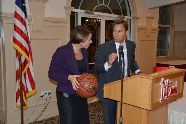 Attorney General Healey is presented with a basketball signed by members of the Lawrence Boys and Girls Club